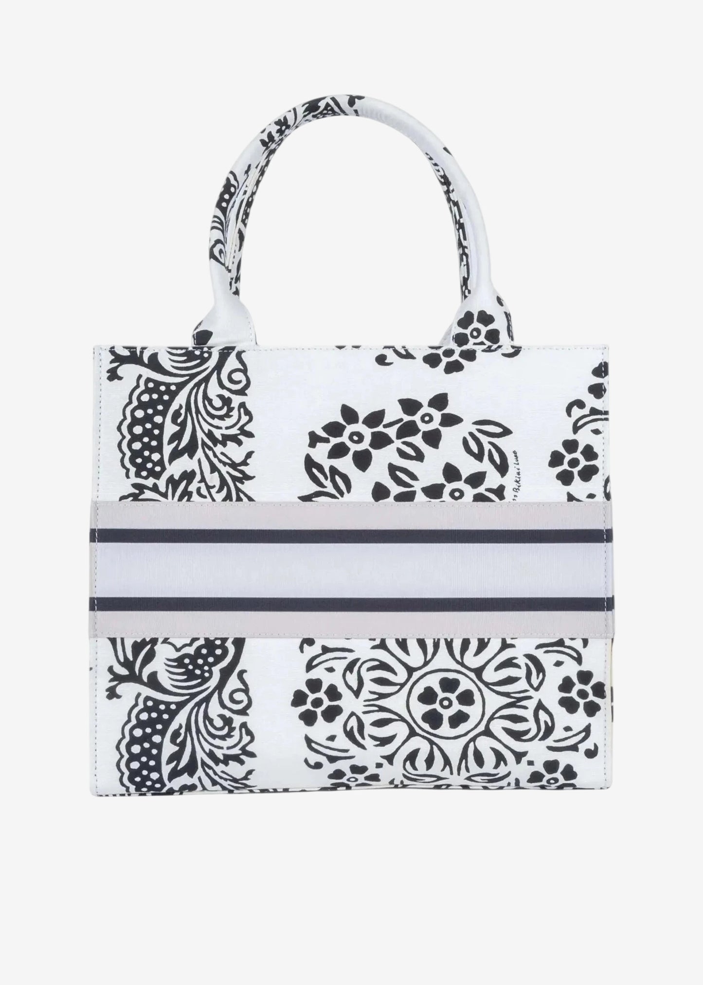 Borsa a mano Miss Bikini in canvas bianco con stampa floreale nera e fascia centrale a righe.