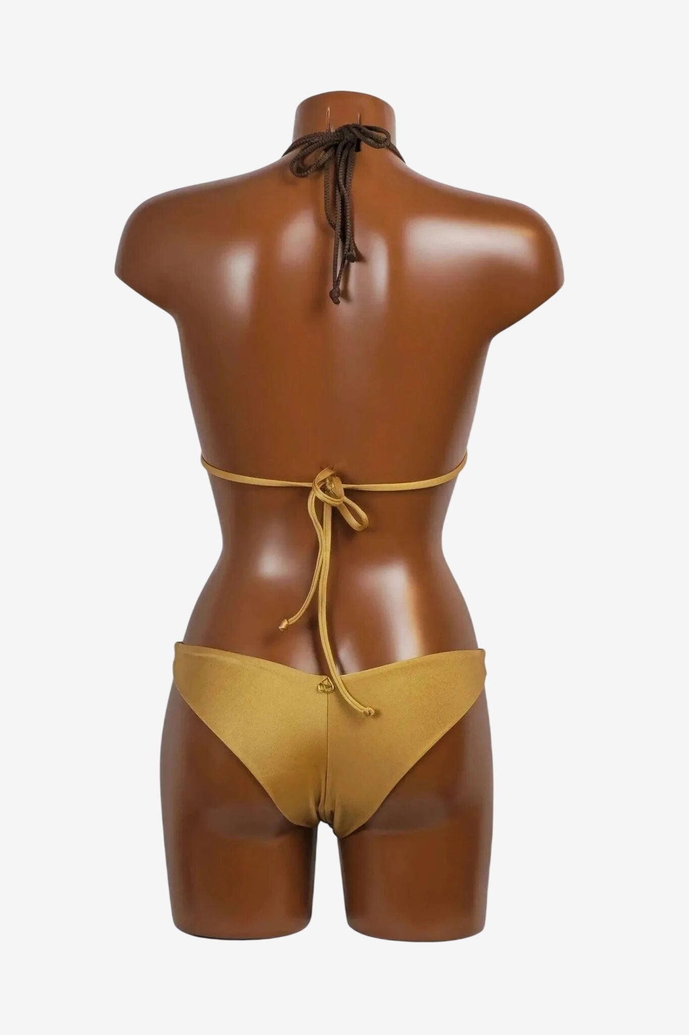 A back view of a sand-colored triangle bikini on a mannequin, featuring tie-back straps.