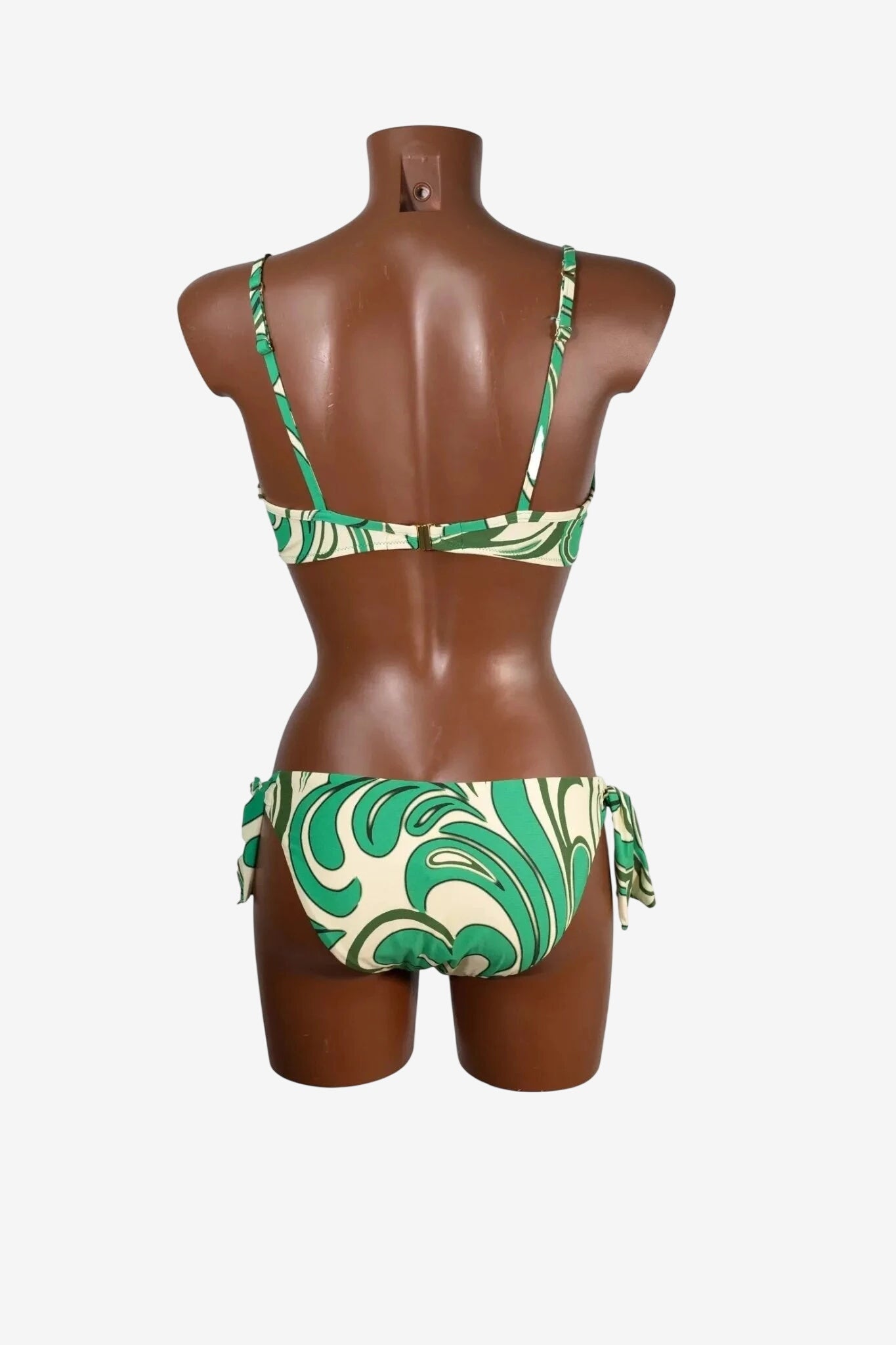 A green and cream swirl print bikini set shown from the back on a mannequin.