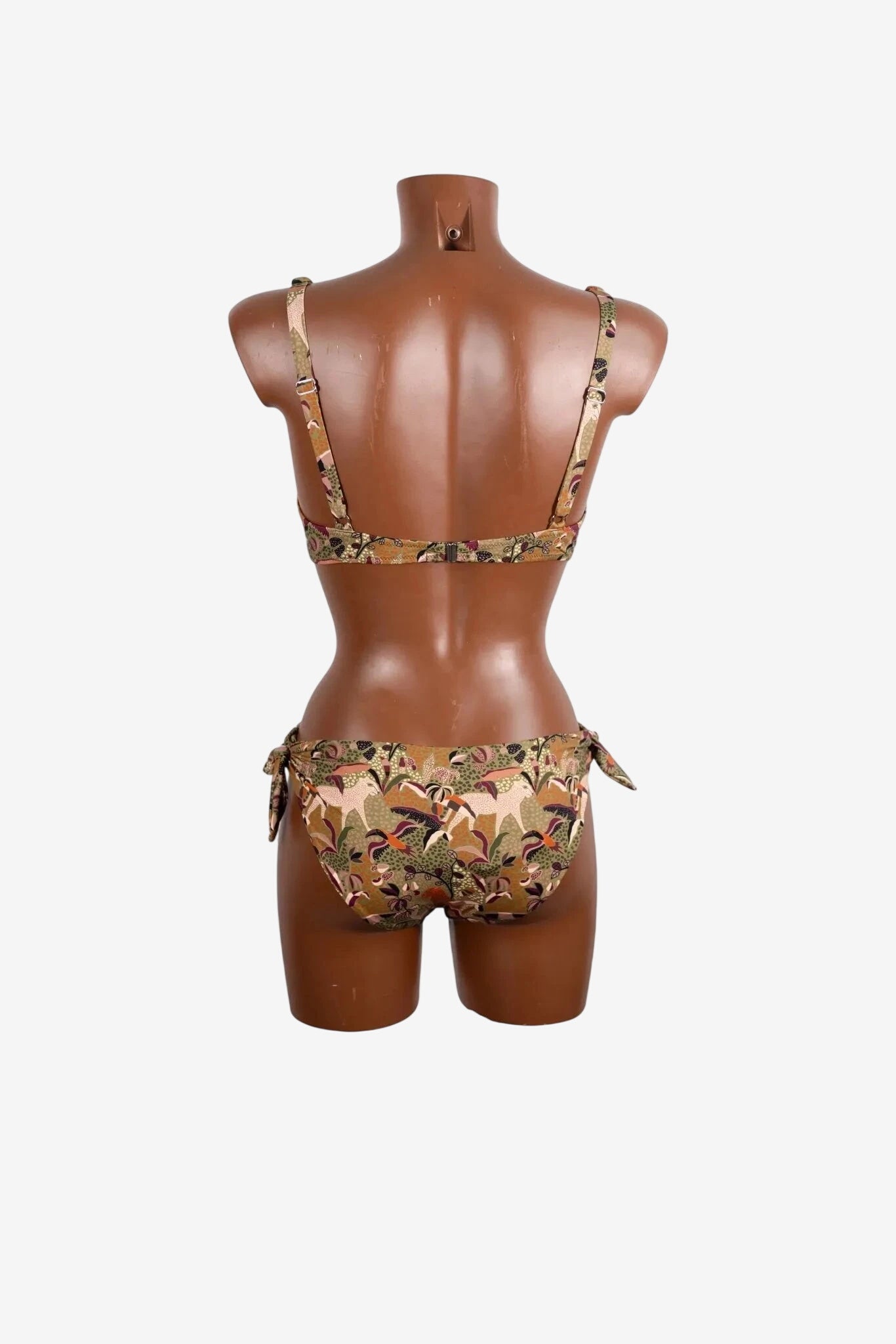 A brown bikini set with a patterned animal and leaf print displayed on a mannequin.
