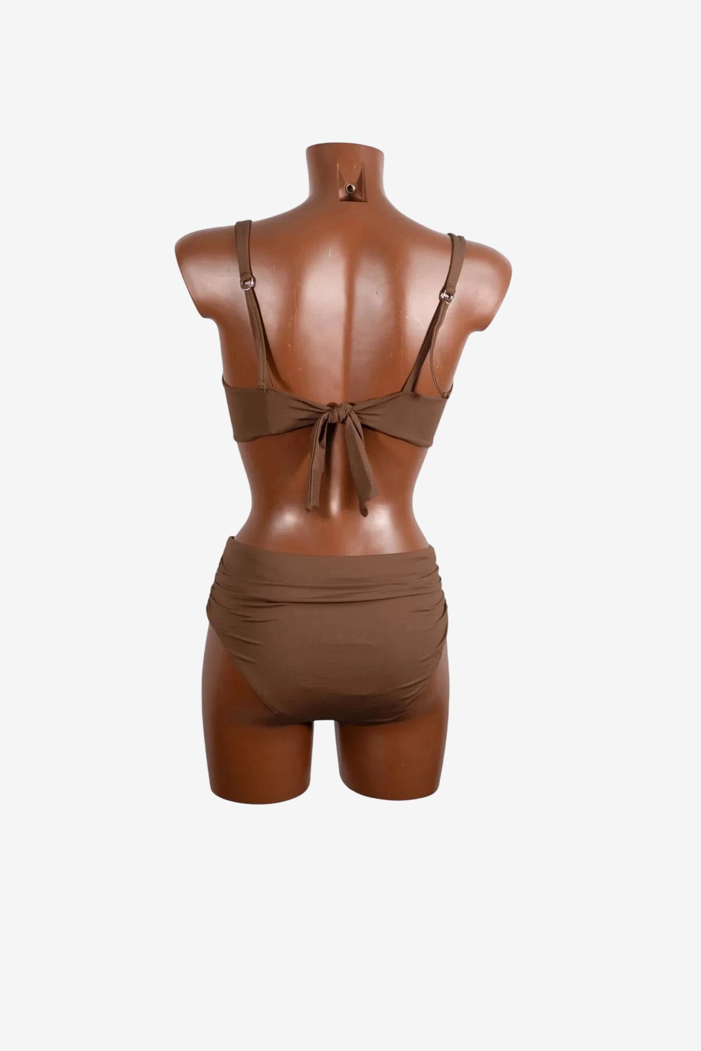 A brown two-piece bikini with a tie-back top and ruched high-waisted bottoms on a mannequin.
