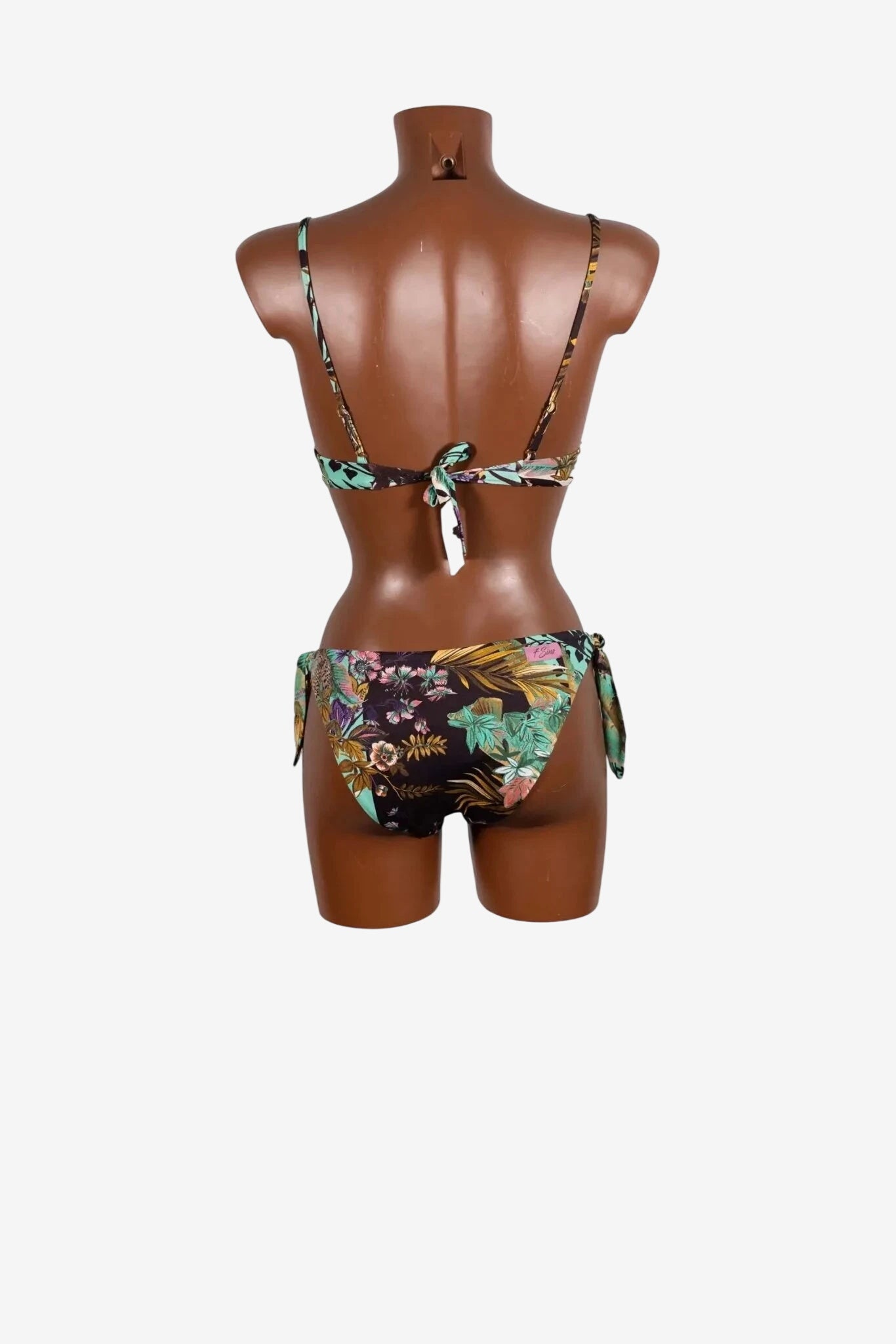A floral print bikini set with a tie-back top and side-tie bottoms on a mannequin.
