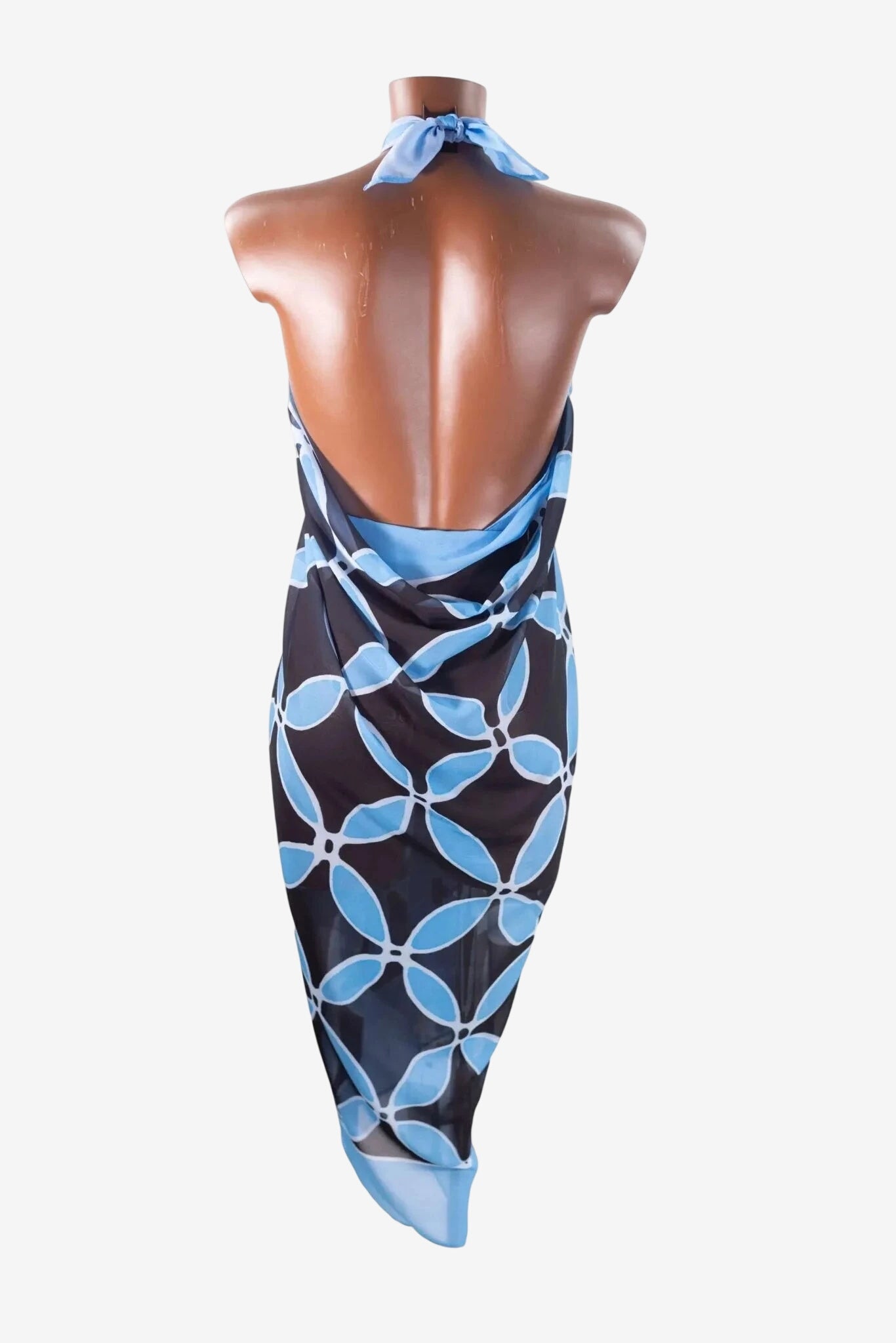 A black and light blue floral print sarong tied as a halter dress on a mannequin.