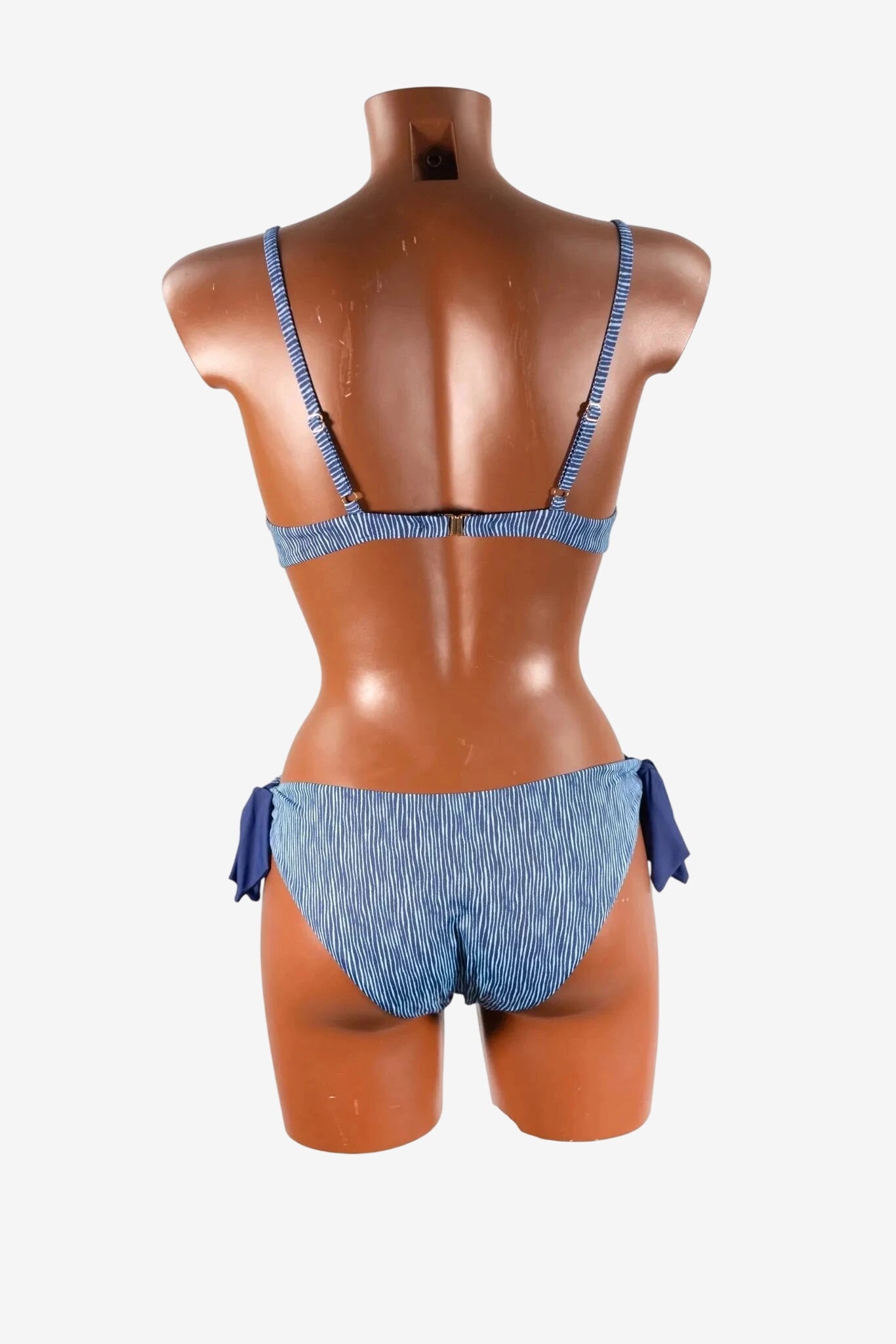A blue and white striped bikini set shown from the back on a mannequin.