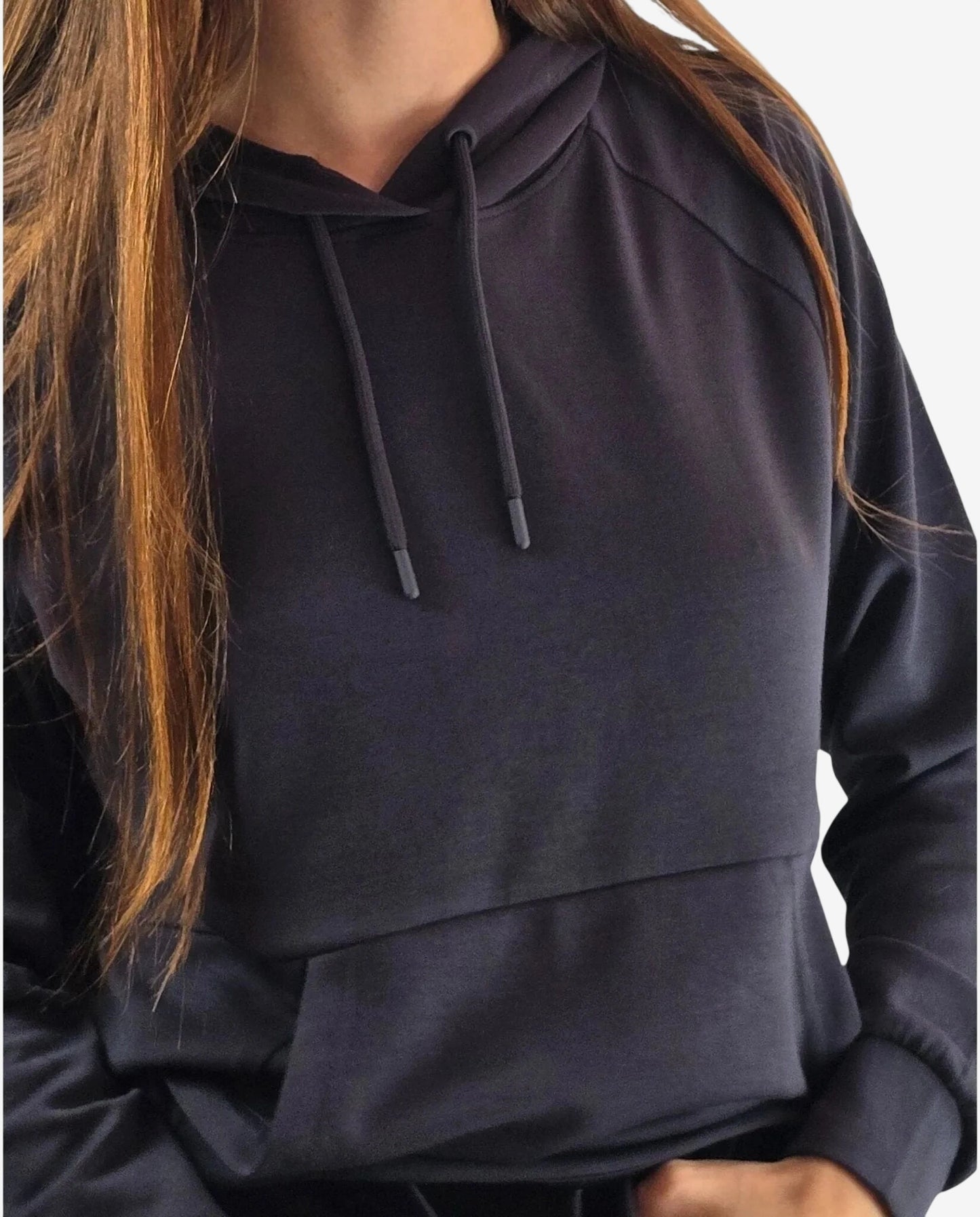 Felpa sportiva nera con cappuccio e tasca frontale indossata da una donna.