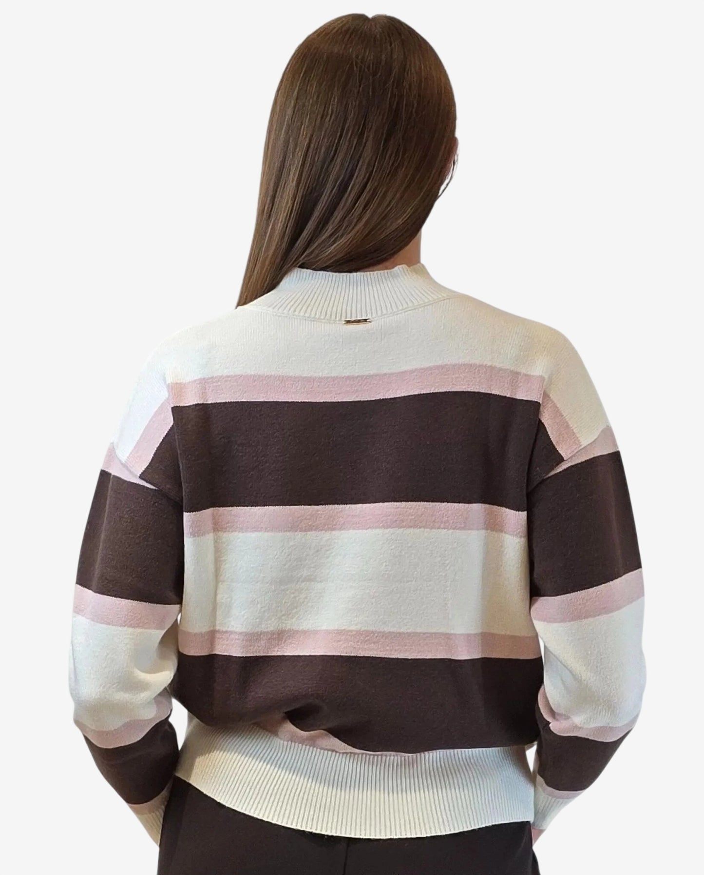 A person wears a long-sleeved pullover featuring horizontal stripes in cream, mocha, and blush pink.