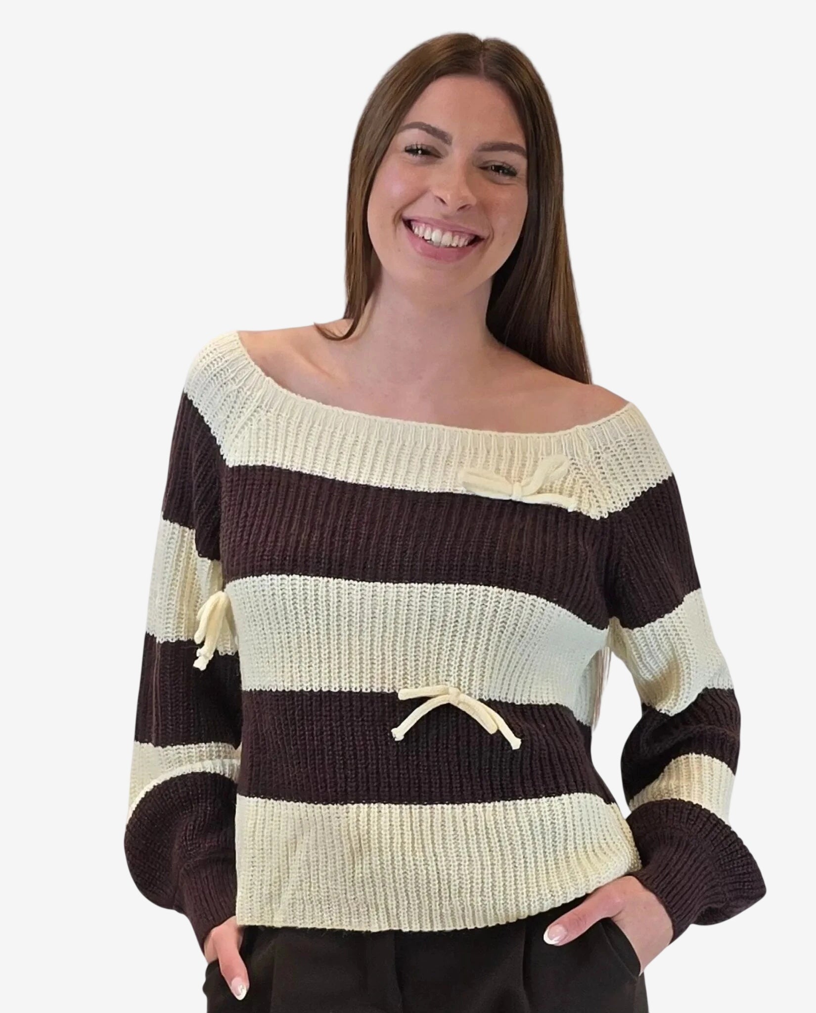 A woman wears a cream and brown striped off-the-shoulder sweater featuring small ribbon details.