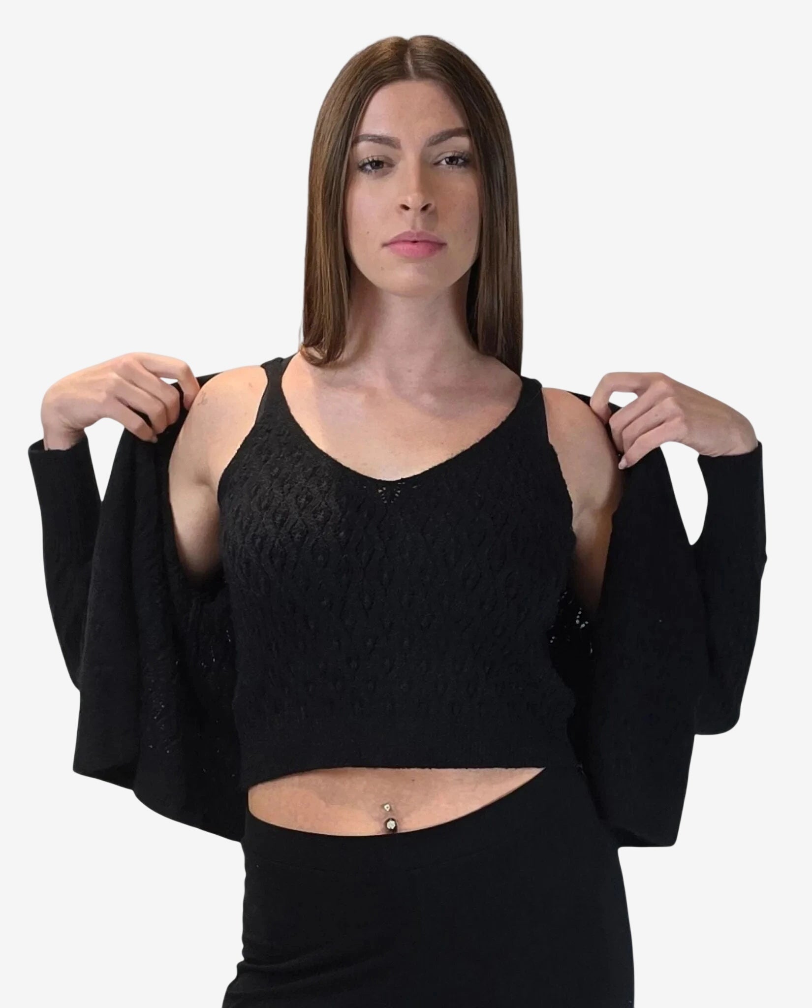 A woman wears a black textured knit tank top and a matching open cardigan.