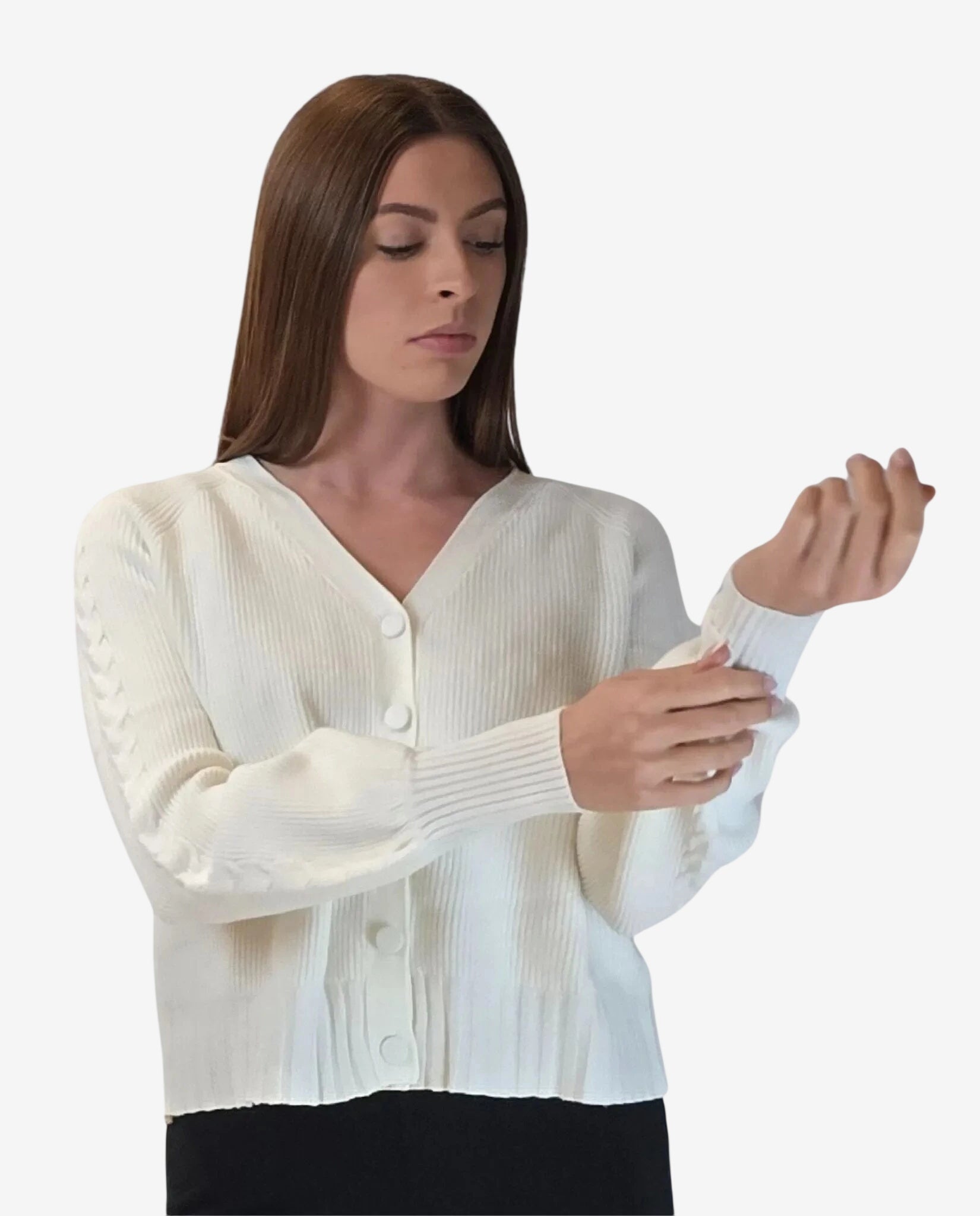 A woman wears a white, long-sleeved, ribbed knit cardigan with a V-neck and button-down front.