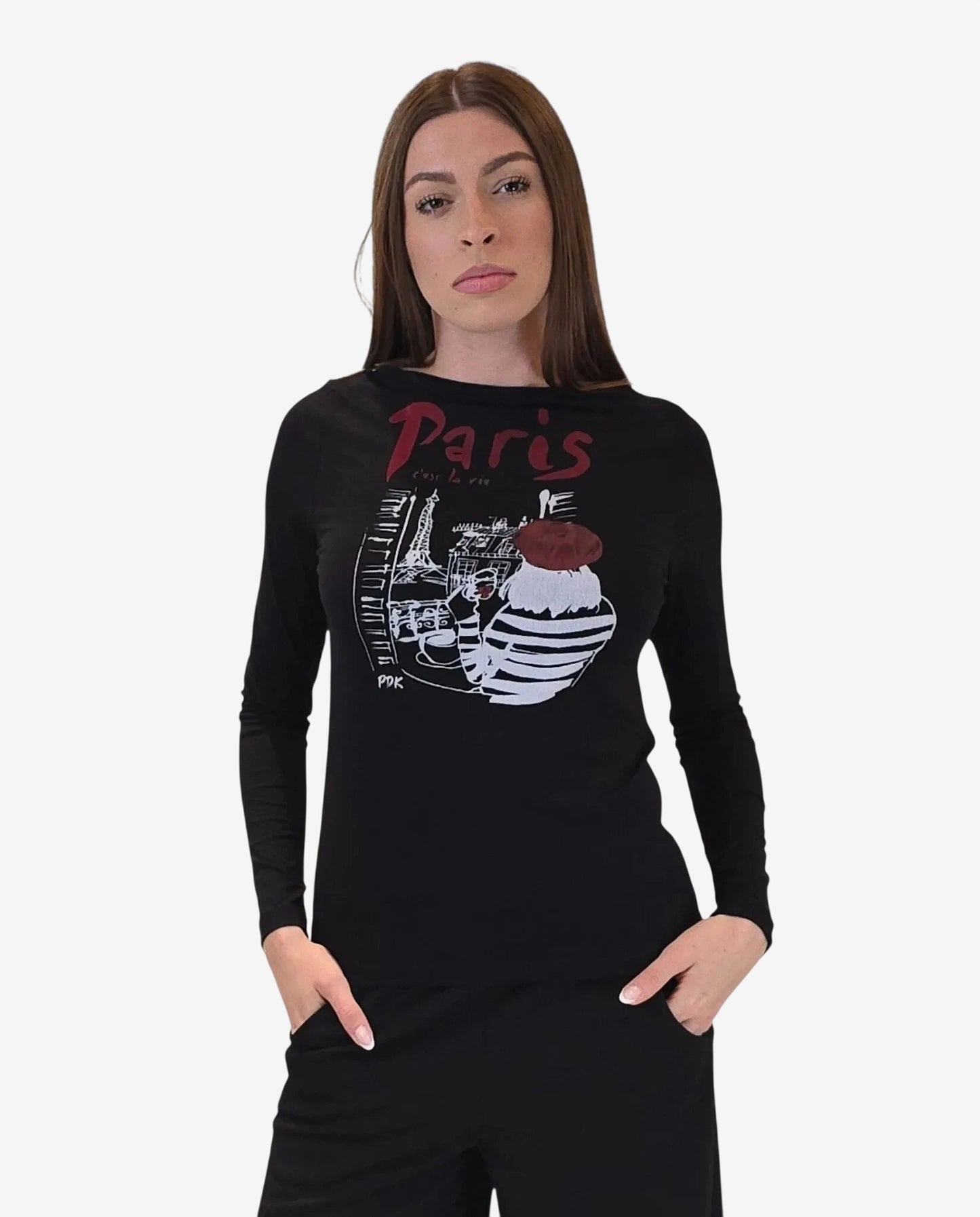 Una modella indossa una maglia nera a maniche lunghe con una stampa grafica parigina sul petto.