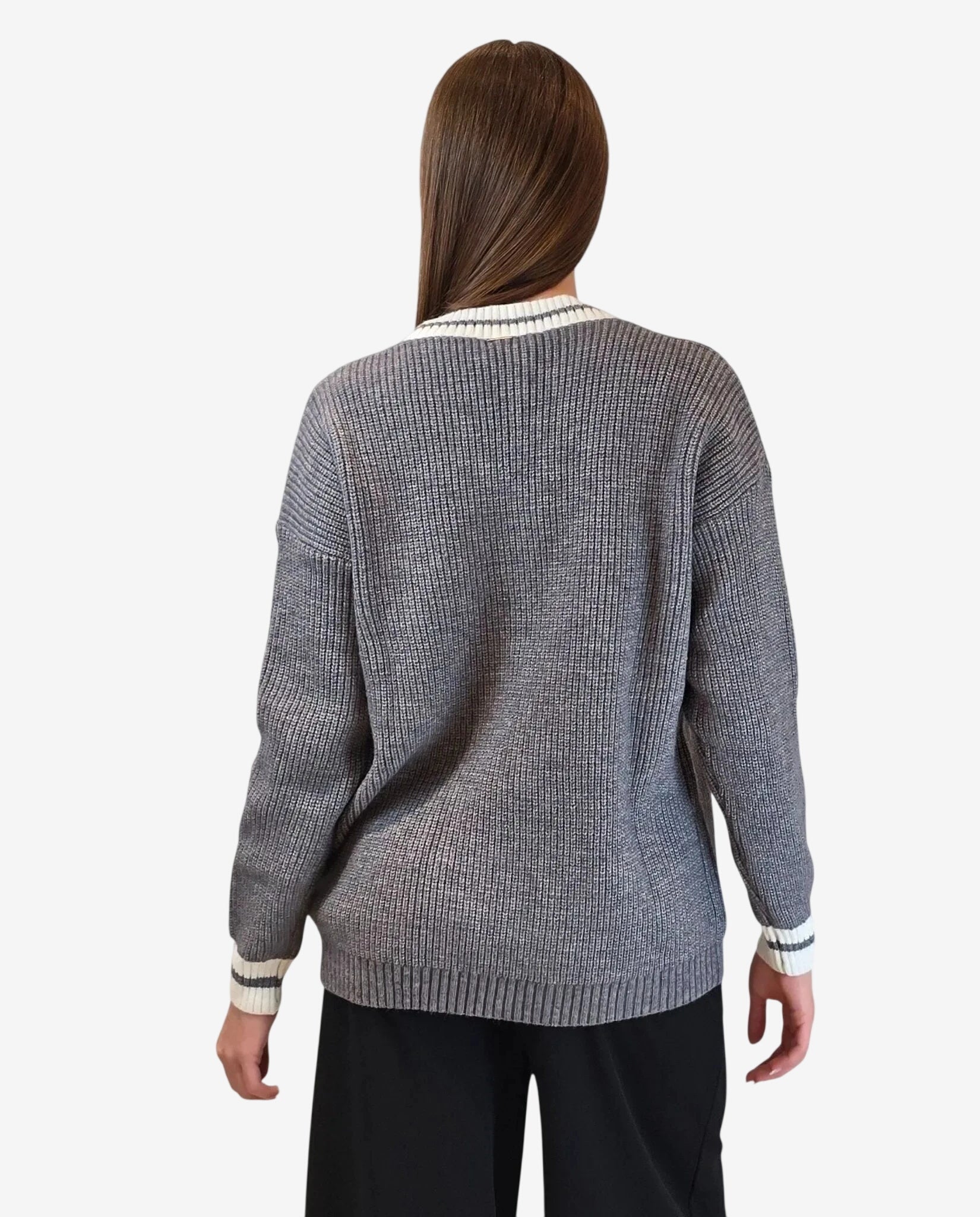 Cardigan grigio a maglia con bordi a righe bianche e scure visto di spalle.