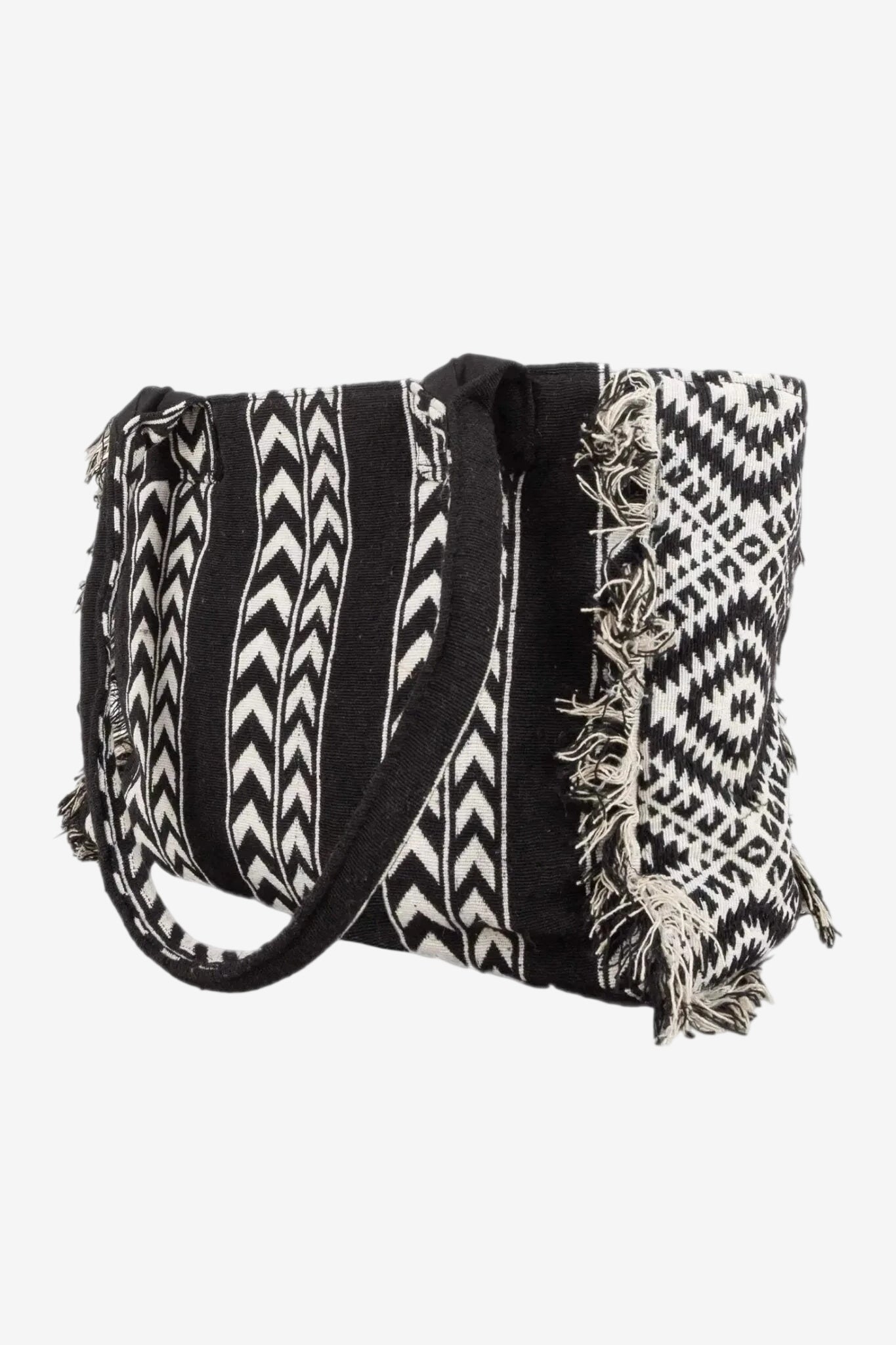 Borsetta a mano con fantasia etnica in bianco e nero e frange decorative sui lati.