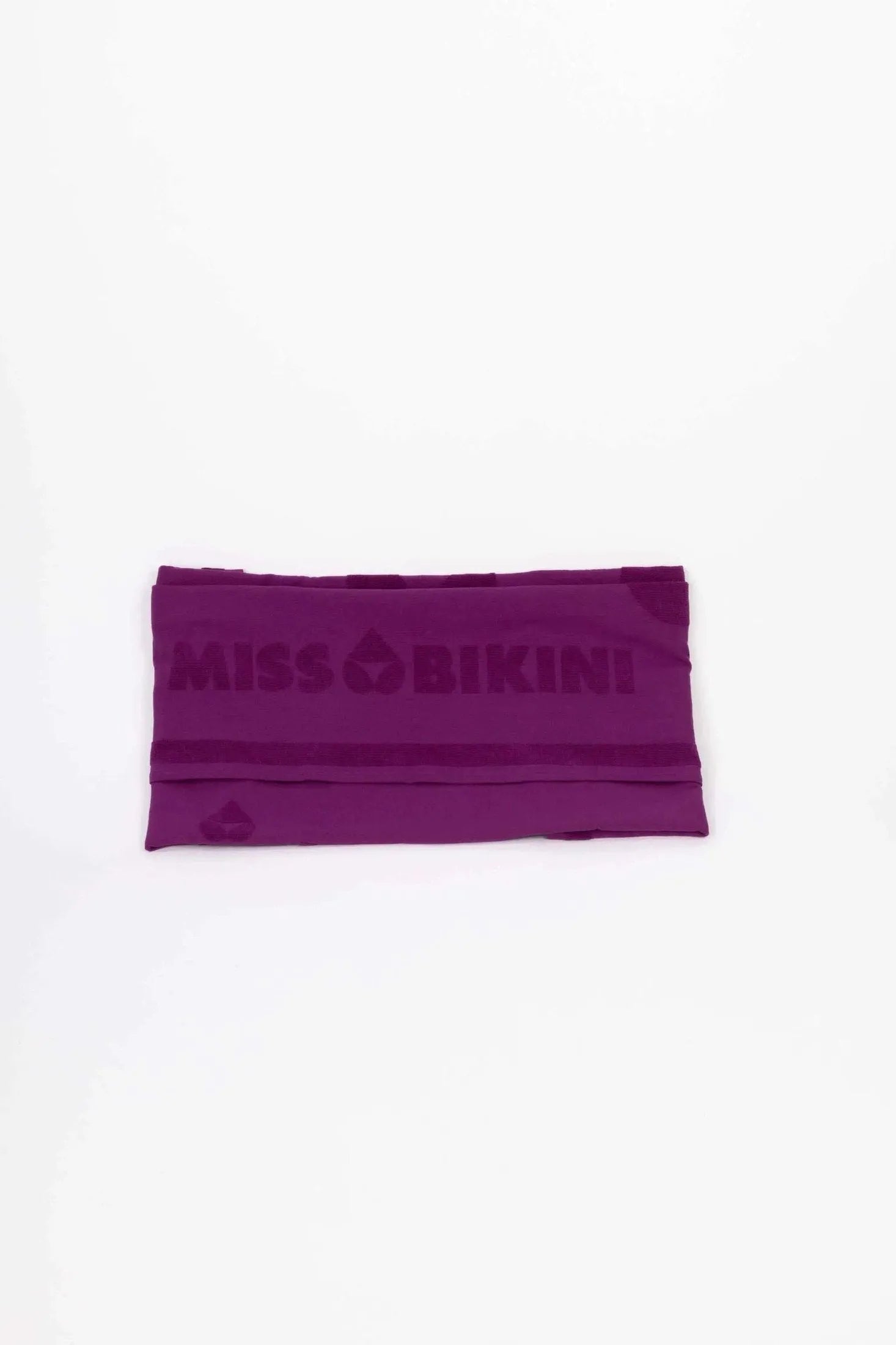 Telo mare in spugna fucsia con logo Miss Bikini in rilievo.