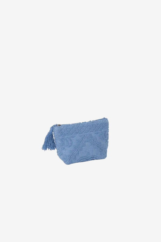 Pochette azzurra in tessuto operato con chiusura a zip e nappa decorativa laterale.