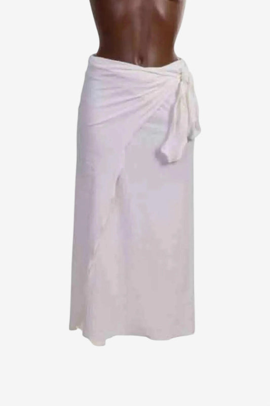A white midi-length pareo skirt made from textured fabric with a side tie closure.