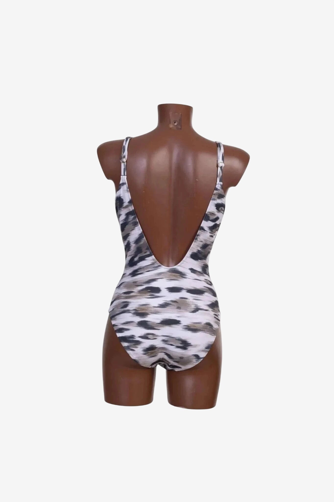 A one-piece swimsuit with a low back and a grey and black animal print on a mannequin.