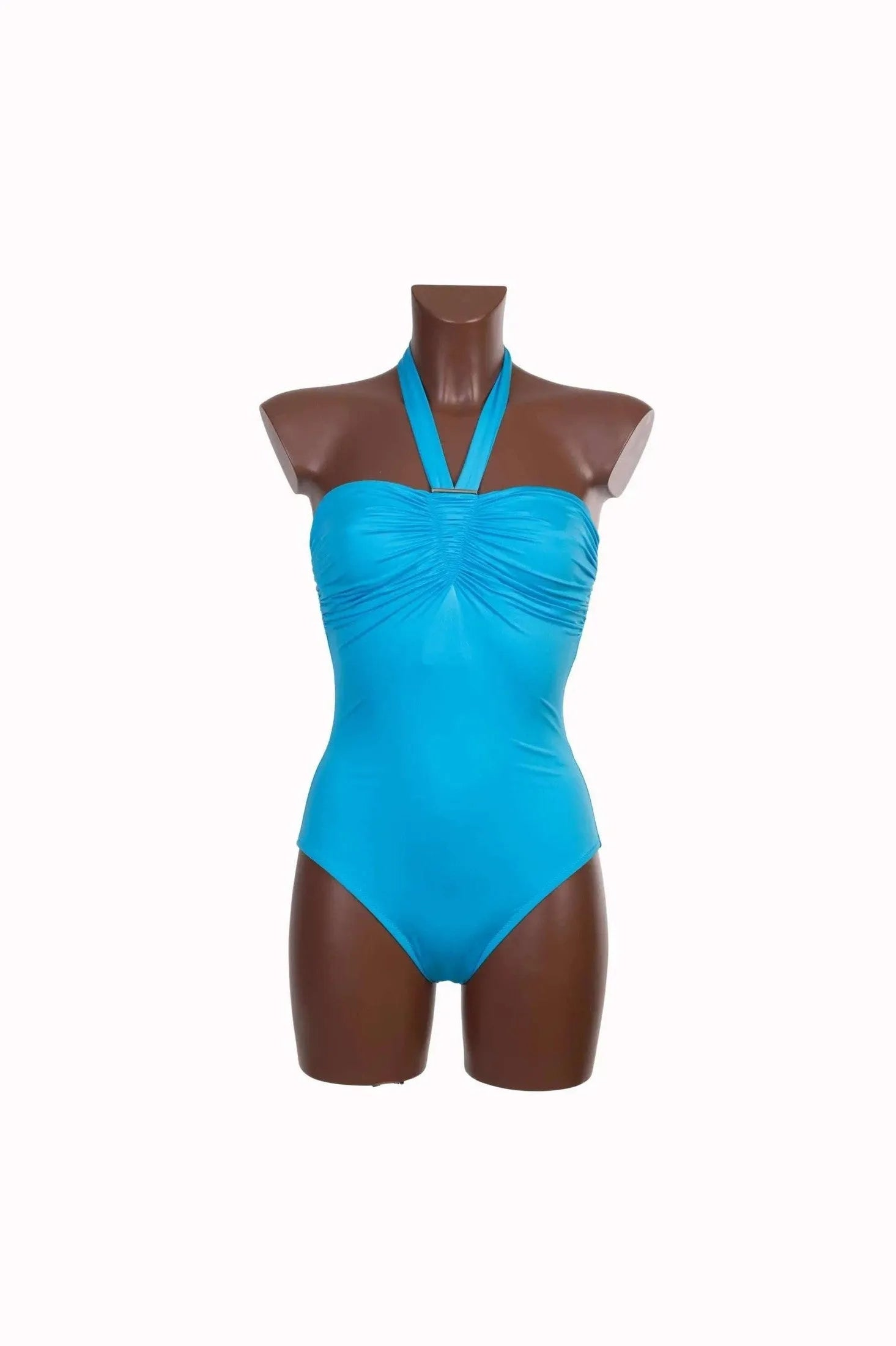 A bright blue one-piece swimsuit with a ruched bodice and a halter neckline on a mannequin.