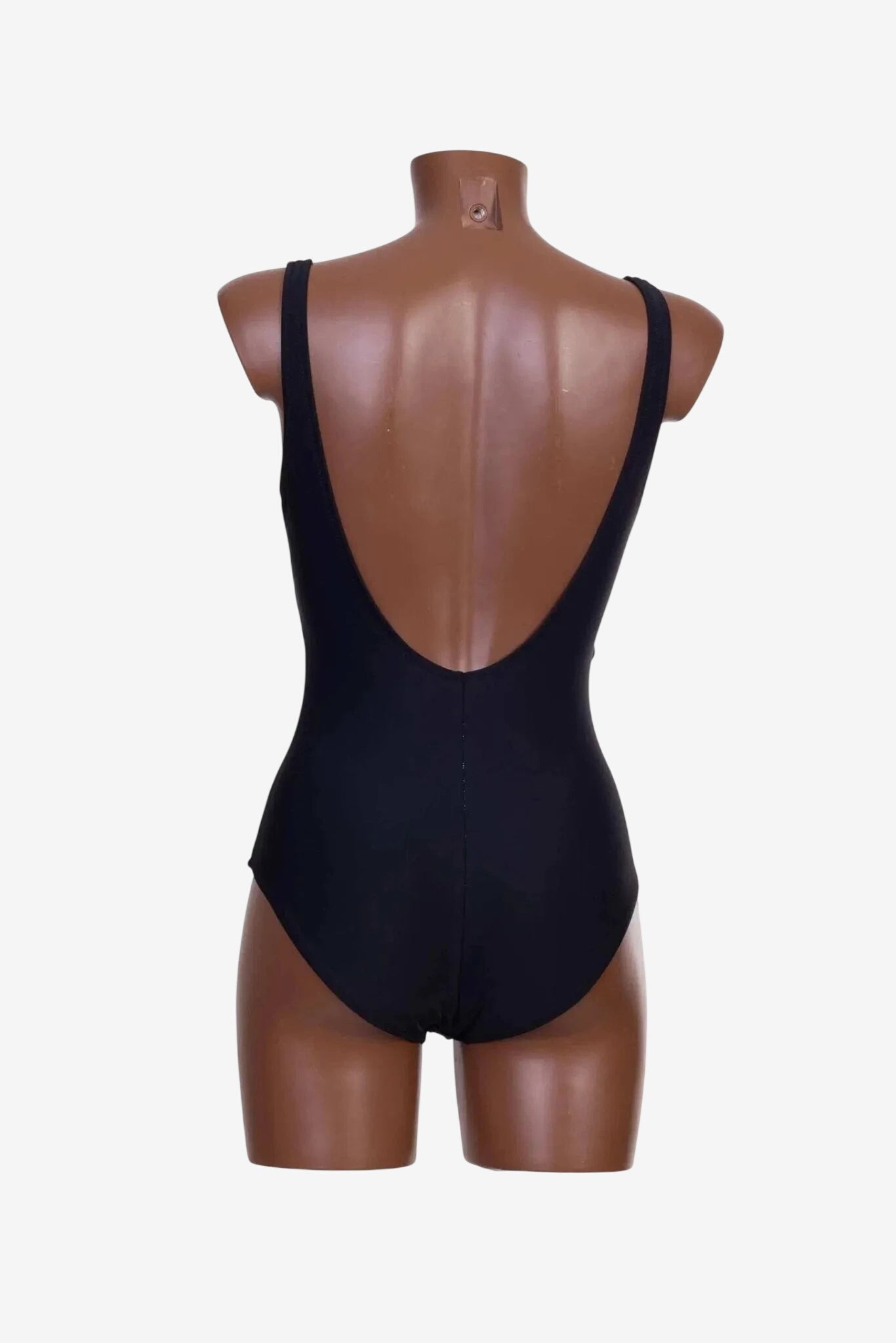 A black one-piece swimsuit with a deep scoop back displayed on a mannequin.
