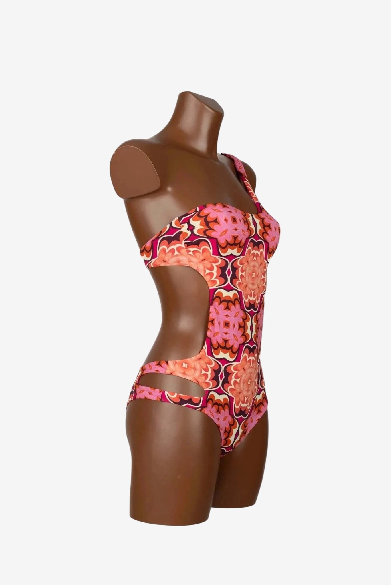 Costume intero trikini monospalla Miss Bikini con fantasia geometrica color corallo.