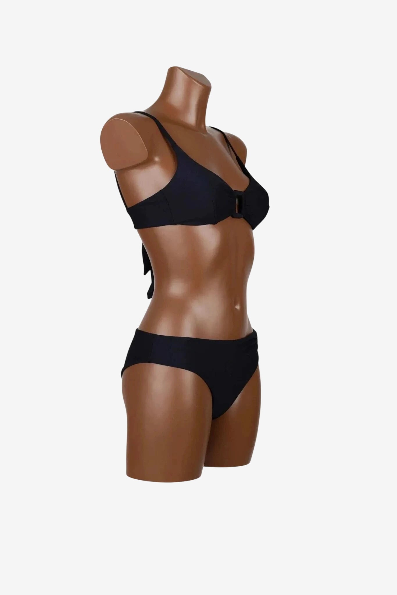 A black bikini bralette set displayed on a mannequin torso.