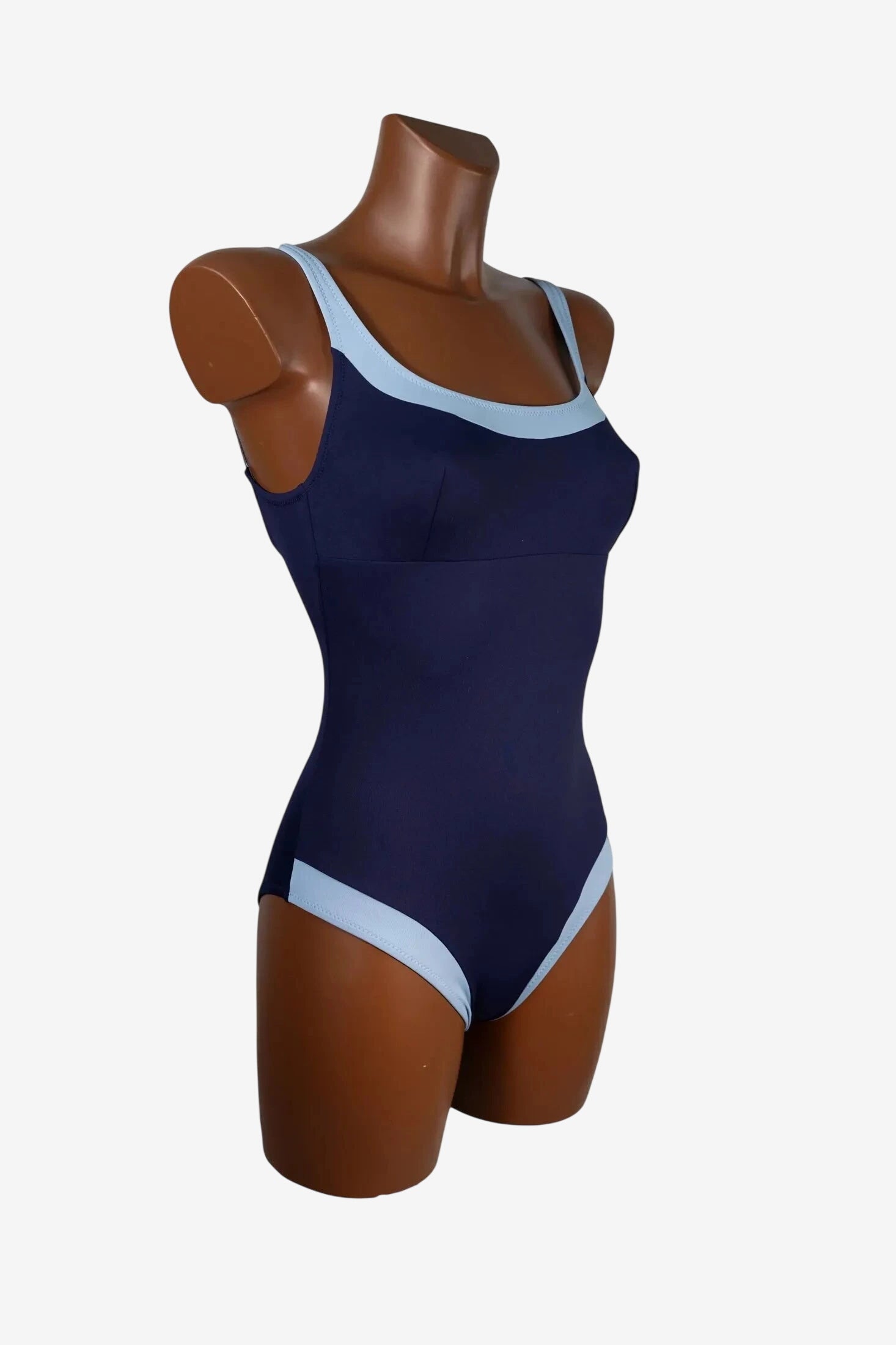A navy blue one-piece swimsuit with light blue trim on the neckline and leg openings.