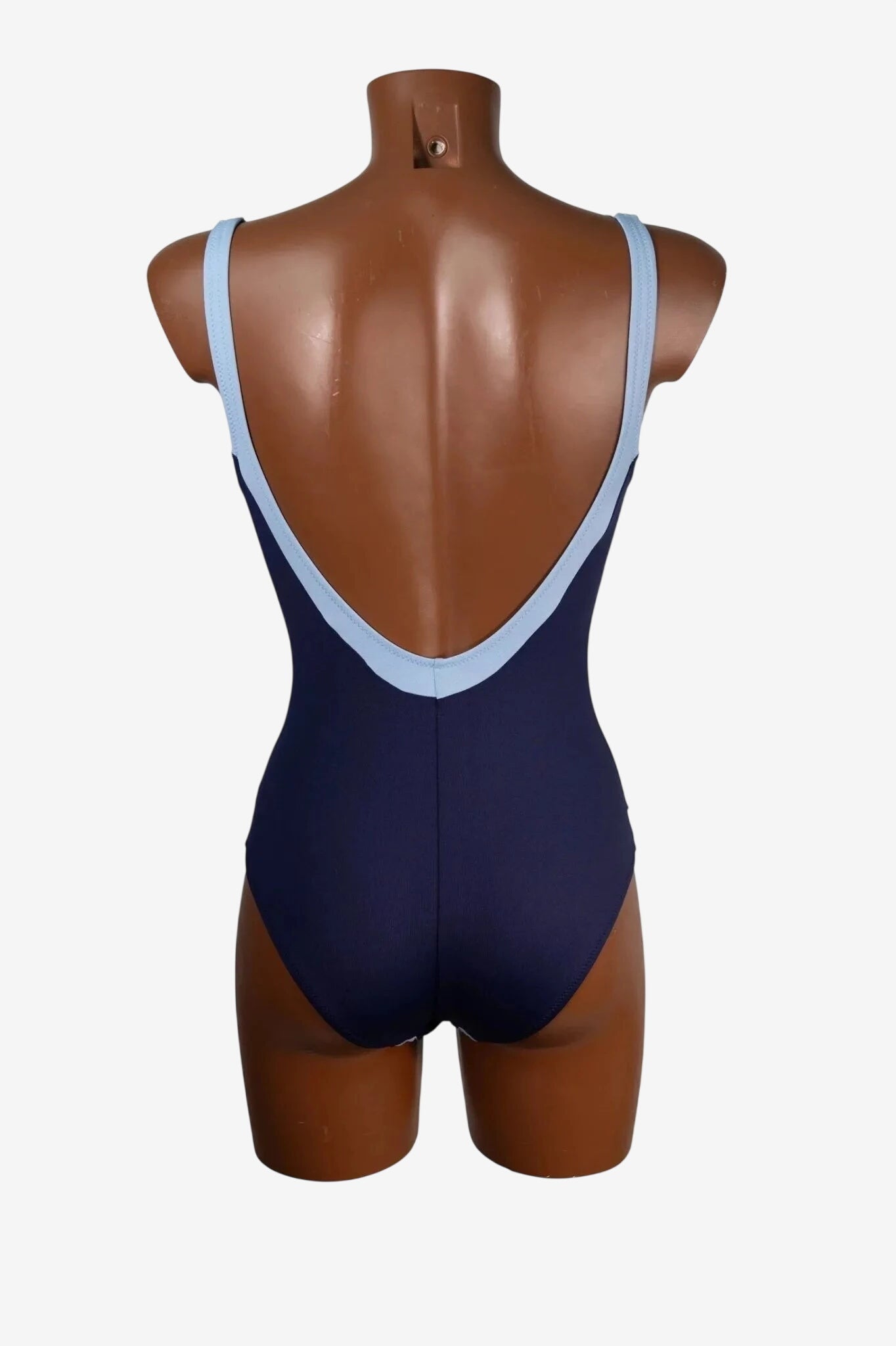 A dark blue one-piece swimsuit with light blue trim on a mannequin back view.