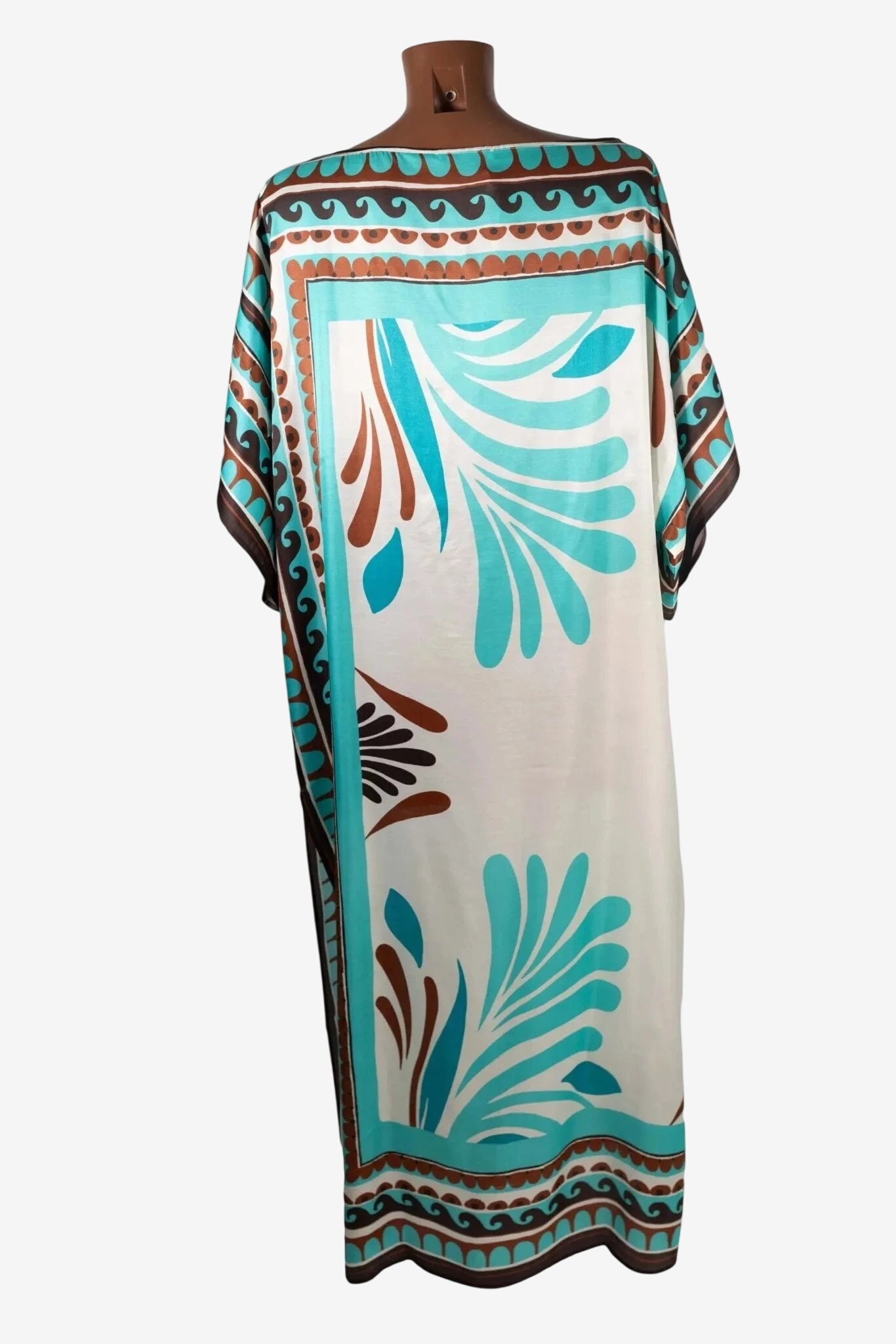 Poncho lungo in seta e viscosa con fantasia tribale nei toni del turchese e marrone.