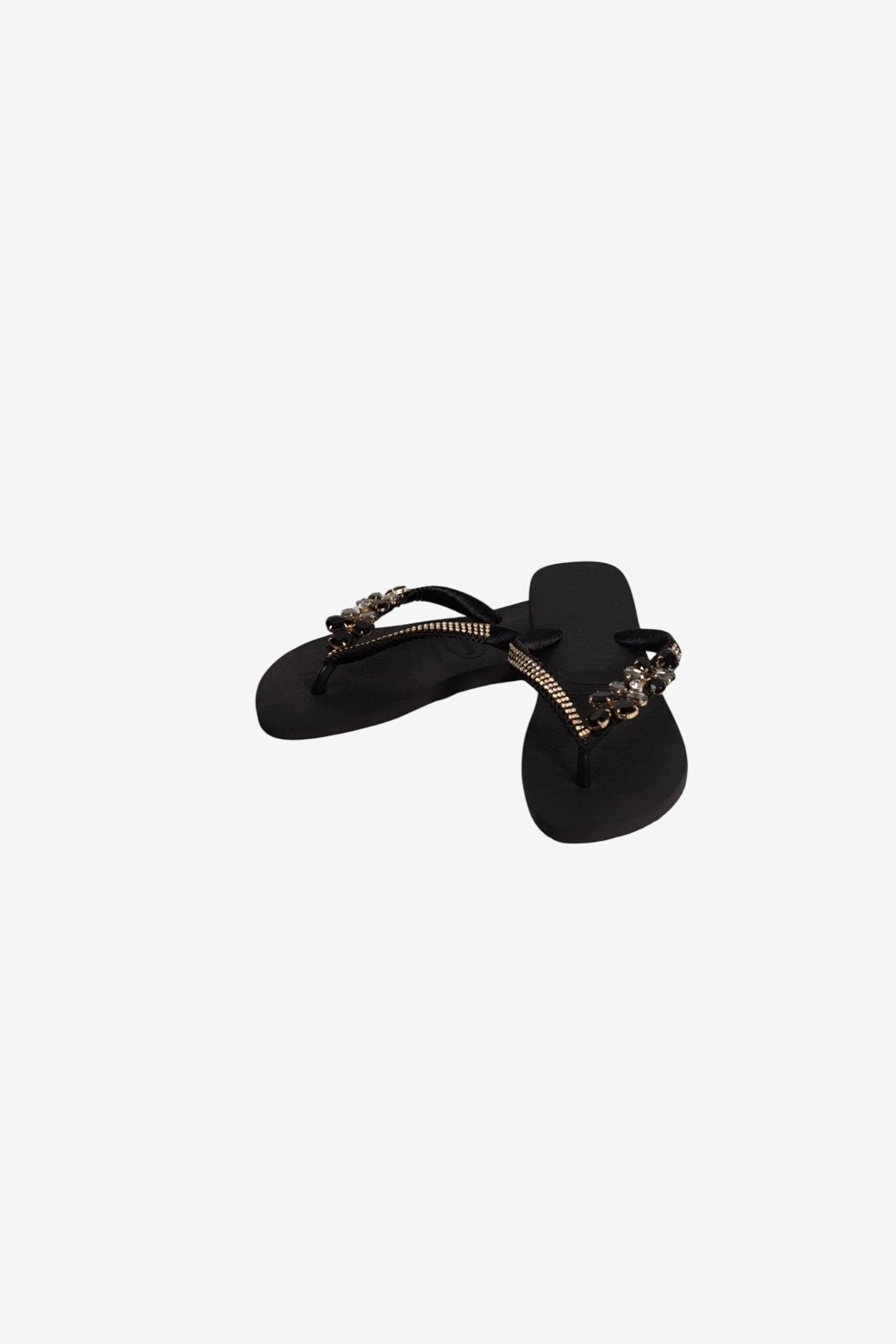 Infradito da donna neri con cinturini decorati da pietre luminose.
