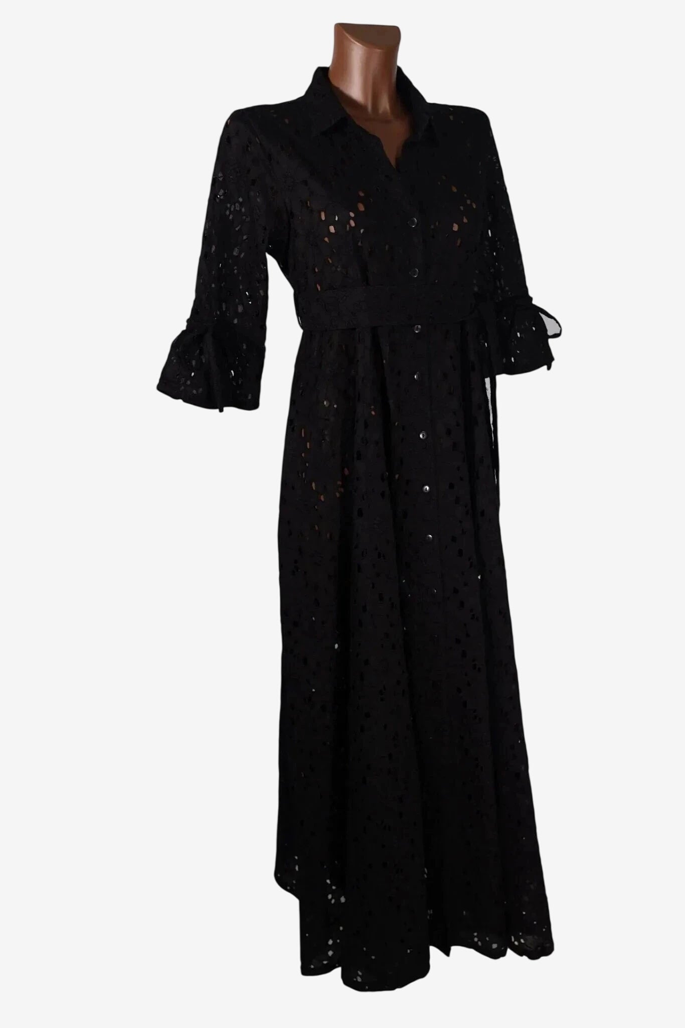 A black button-down midi dress in eyelet lace fabric with three-quarter sleeves and a waist tie.