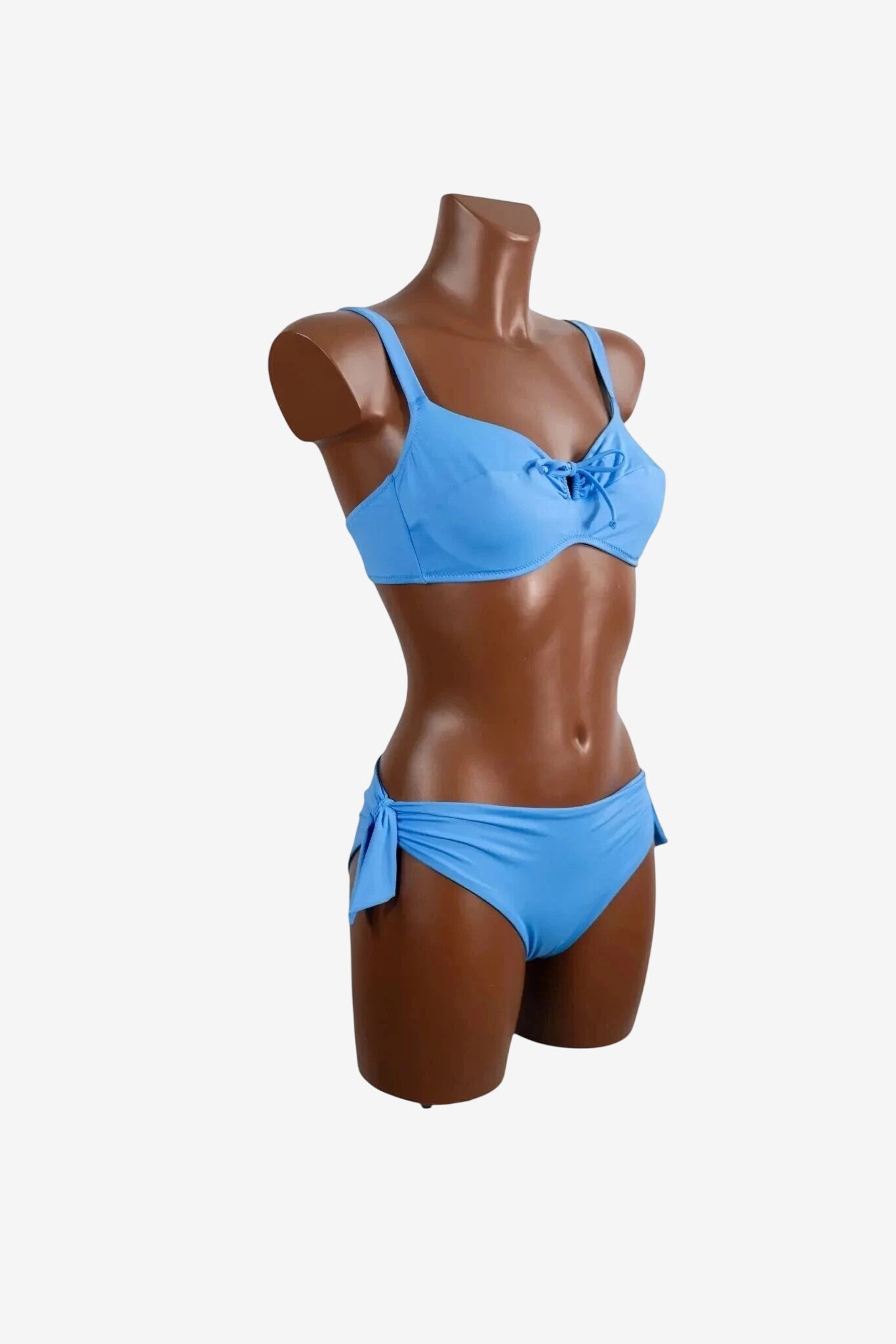 A light blue bikini set featuring a tie-front top and matching side-tie bottoms on a mannequin.