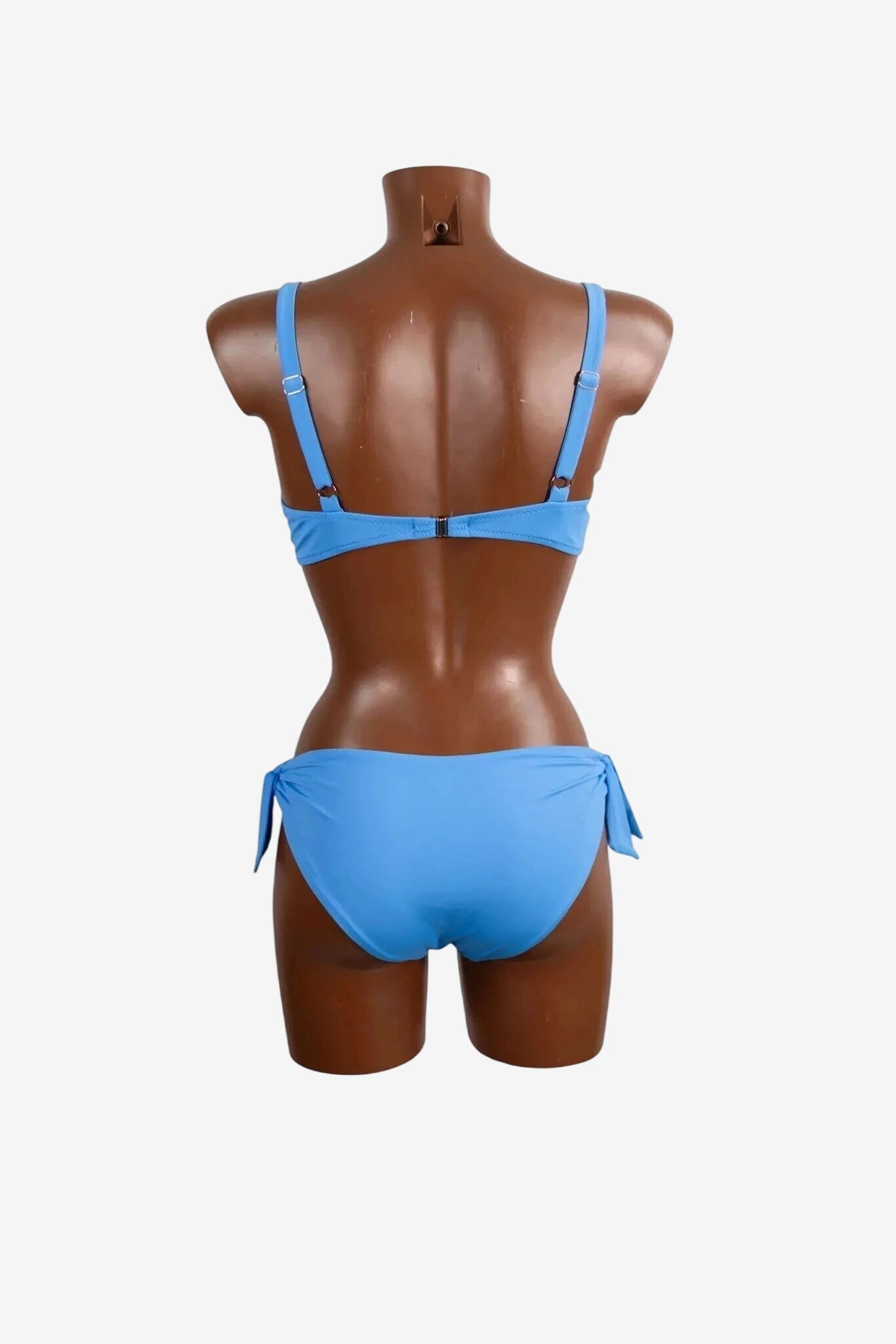 A light blue bikini top and matching side-tie bikini bottom shown from the back on a mannequin.