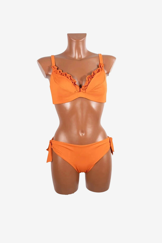 A bright orange bikini set with a ruffled neckline and side-tie bottoms on a mannequin.