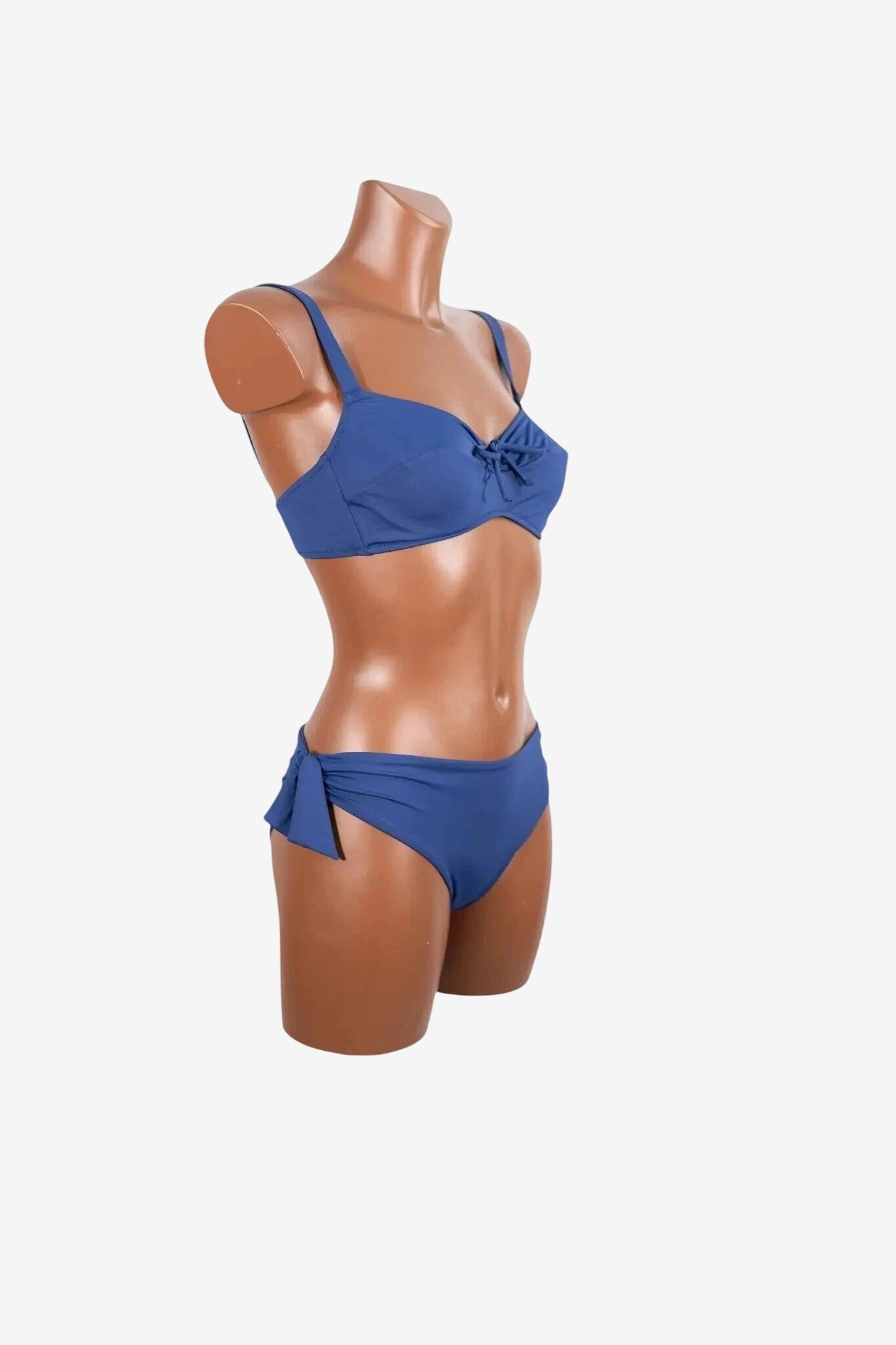 A blue bikini set with a bow detail on the top and side-tie bottoms on a mannequin.