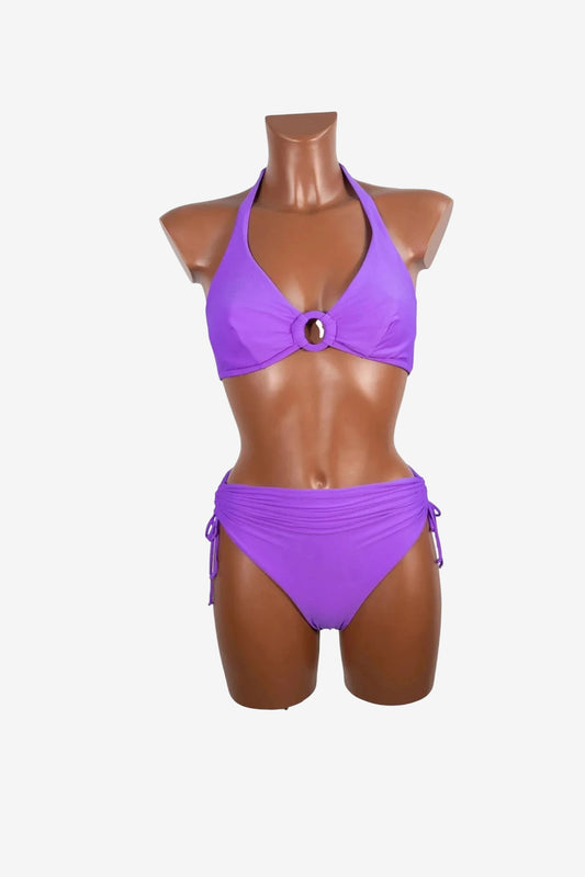 A purple two-piece bikini with a halter top featuring a center ring and ruched side-tie bottoms.