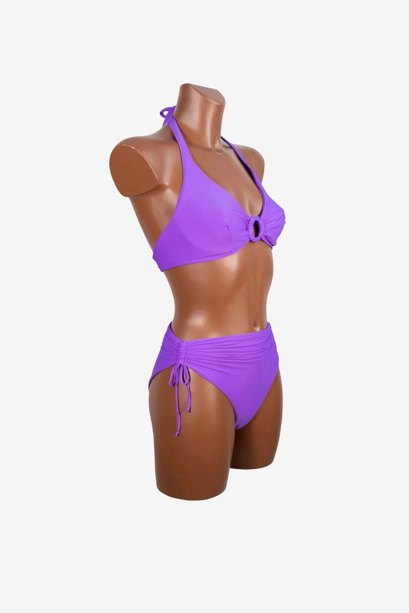 A purple bikini set featuring a halter top with a center ring and high-waisted ruched bottoms.