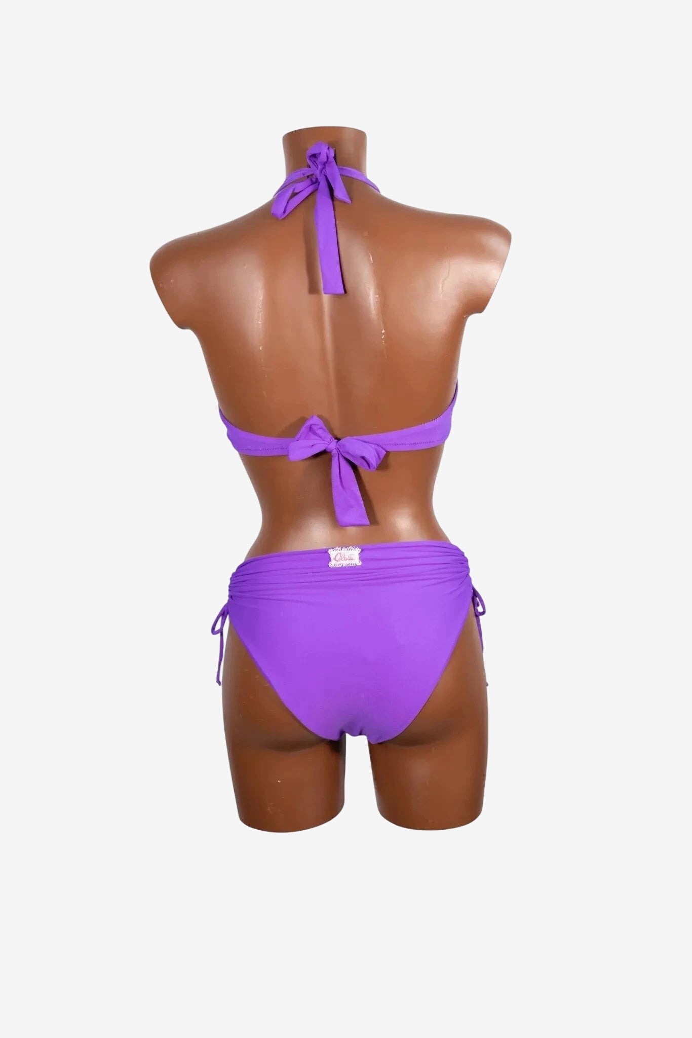 A purple bikini set with a tie-back top and side-tie bottoms on a mannequin.