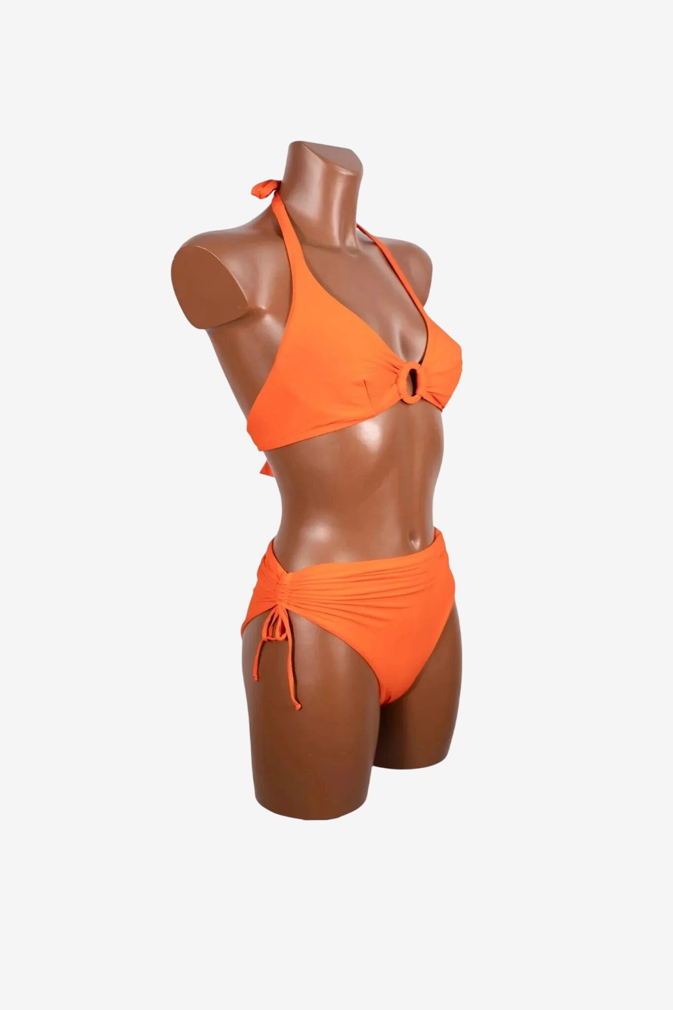 A bright orange bikini set featuring a halter top with a center ring and ruched side-tie bottoms.