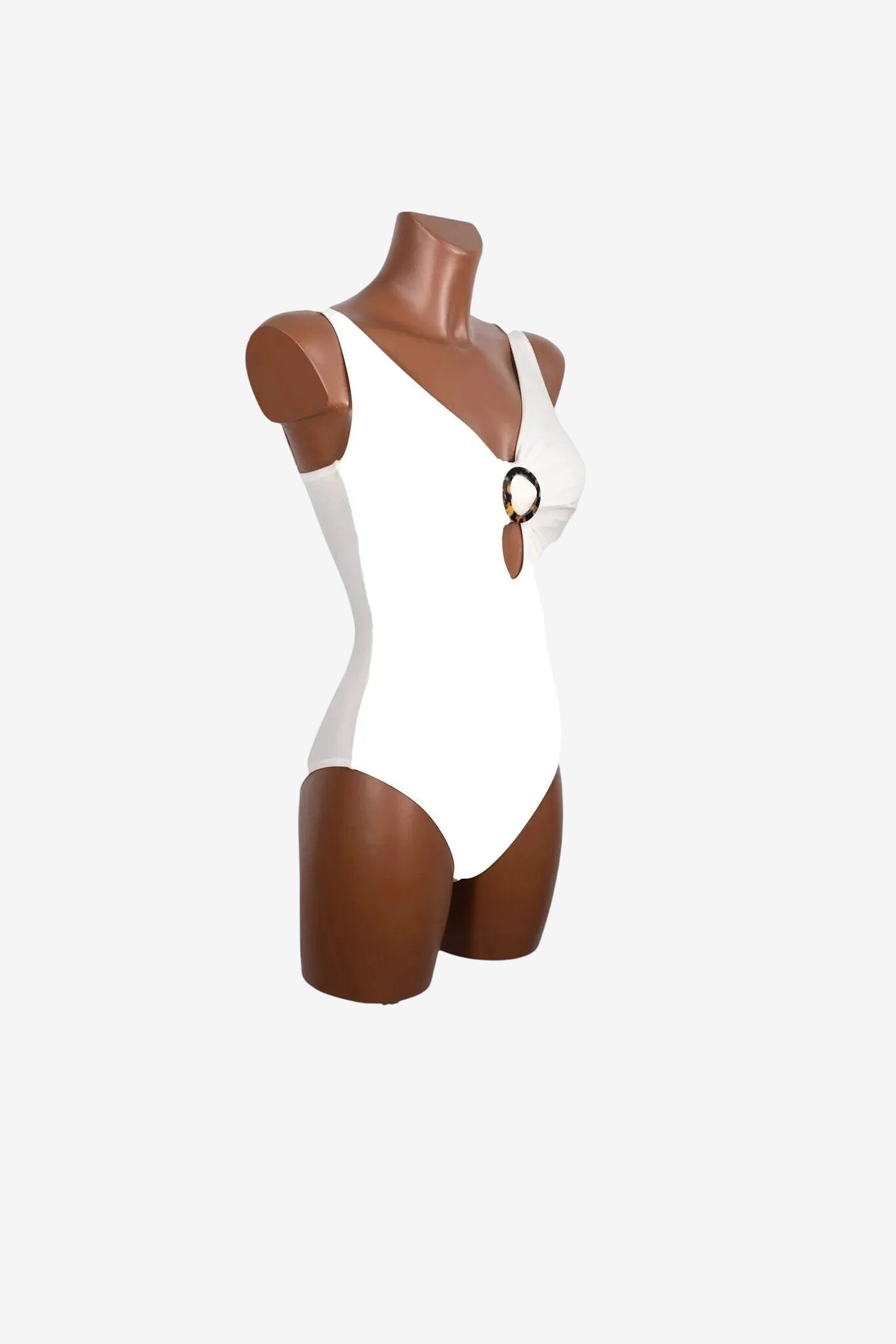 A white one-piece swimsuit on a mannequin featuring a tortoiseshell ring detail at the chest.