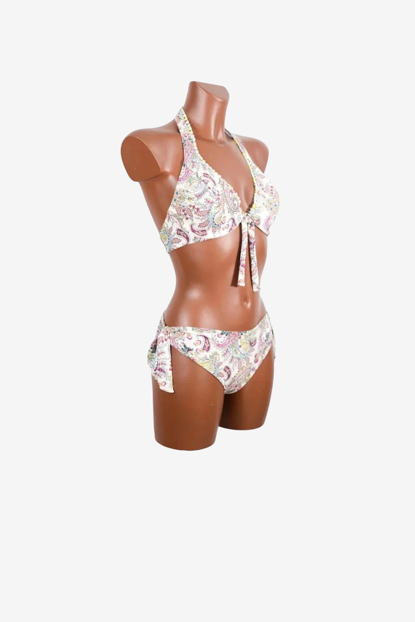 A paisley print bikini with a halter top and side-tie bottoms on a mannequin.