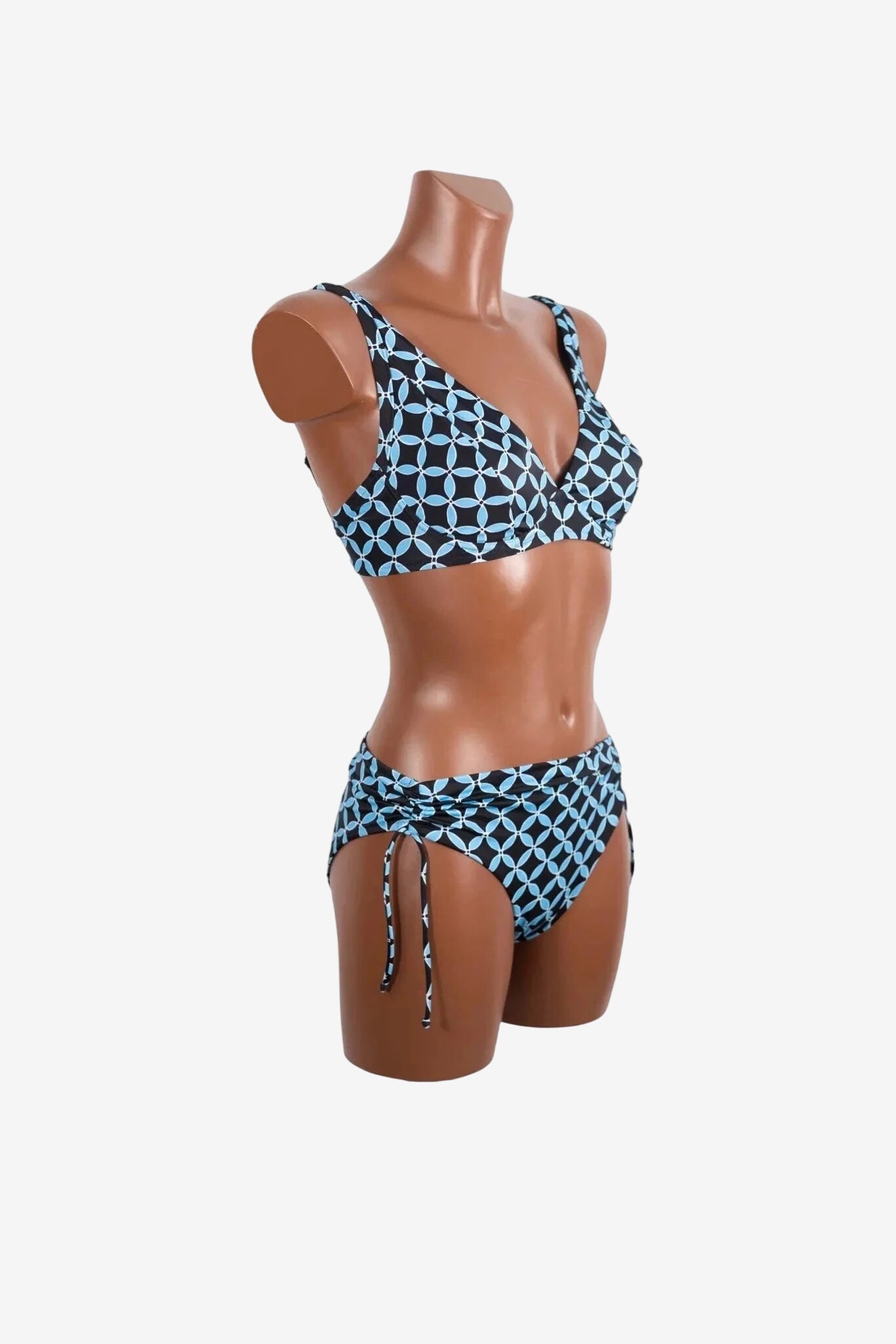 A black and light blue geometric print bikini set with a tie-side bottom on a mannequin.