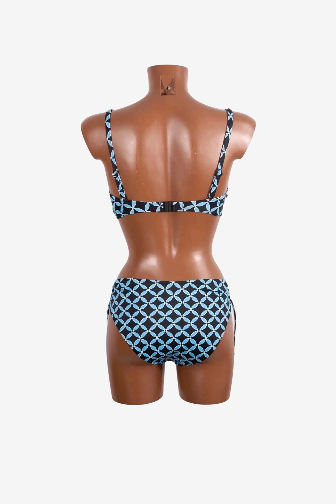 A black and light blue geometric print bikini set shown from the back on a mannequin.