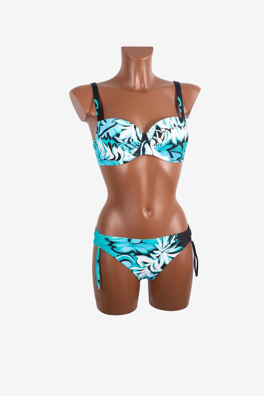 A two-piece bikini with a teal, black, and white floral print on a mannequin.