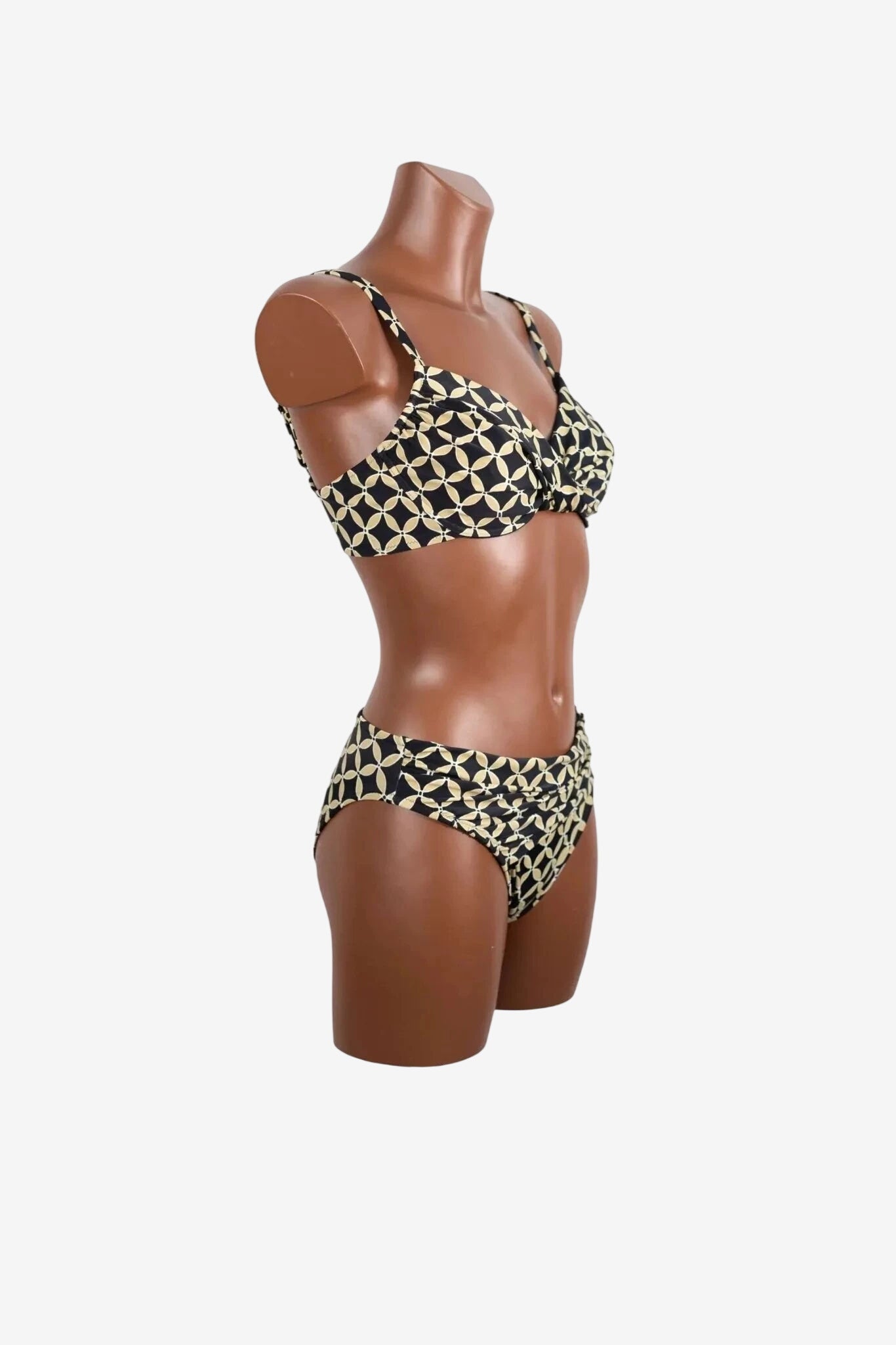 A black and beige geometric print bikini set with an underwire top on a mannequin.