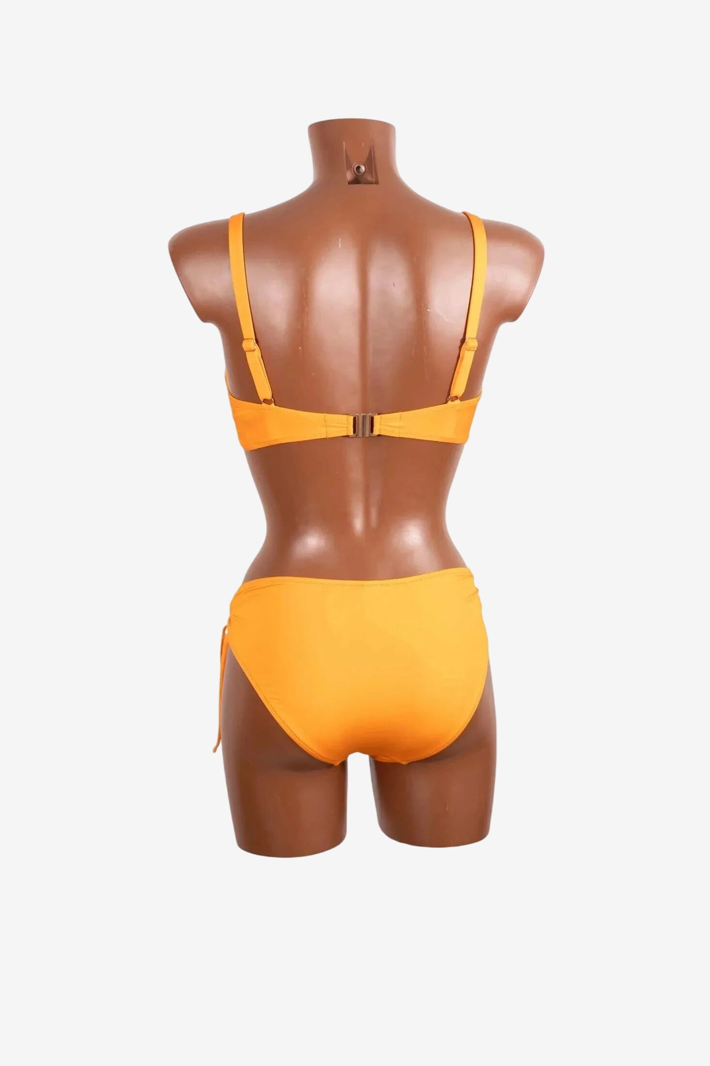 A bright orange bikini set with a back clasp closure displayed on a mannequin.