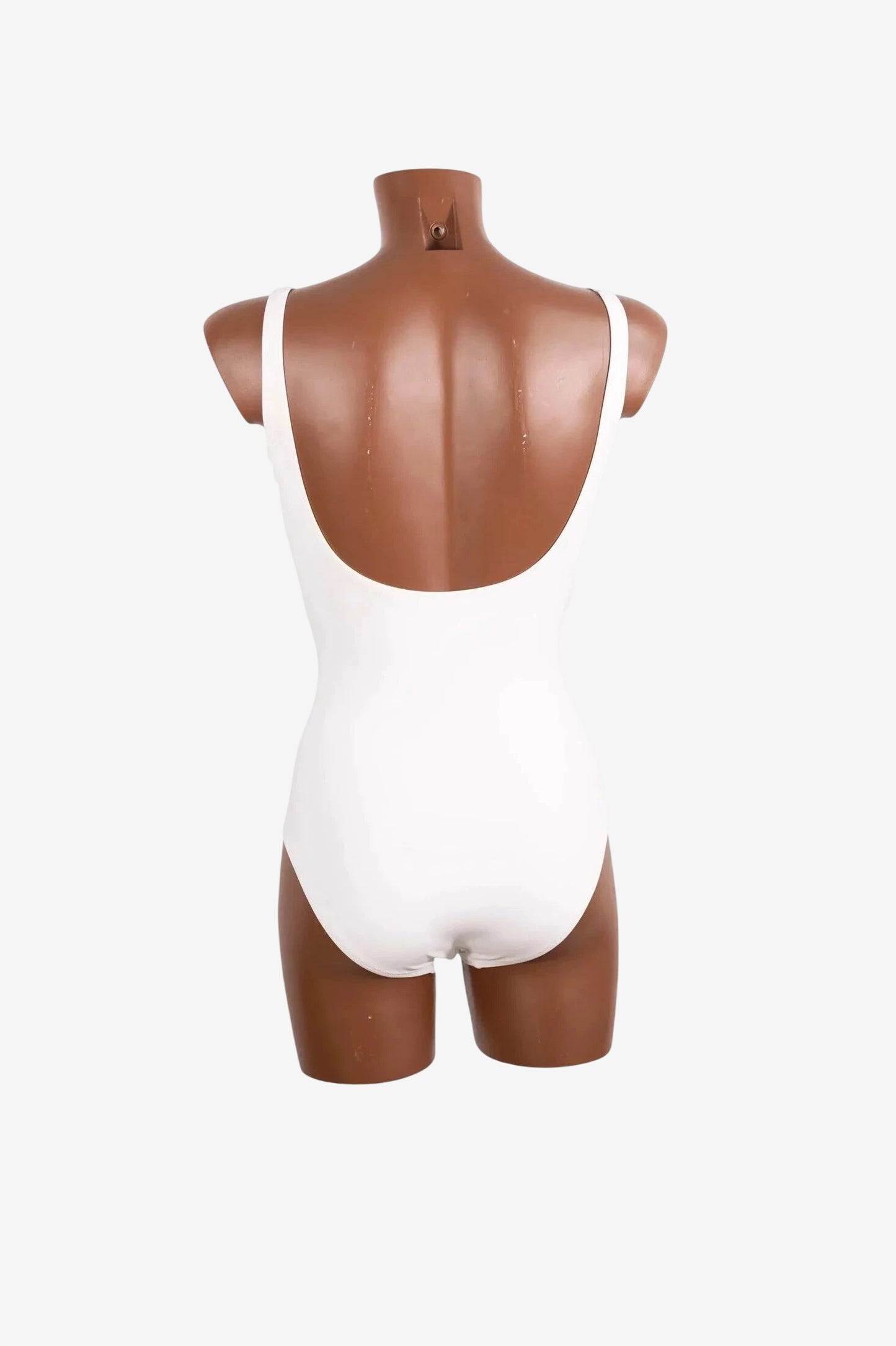 Costume intero bianco Roidal dal design elegante visto di spalle su un manichino.