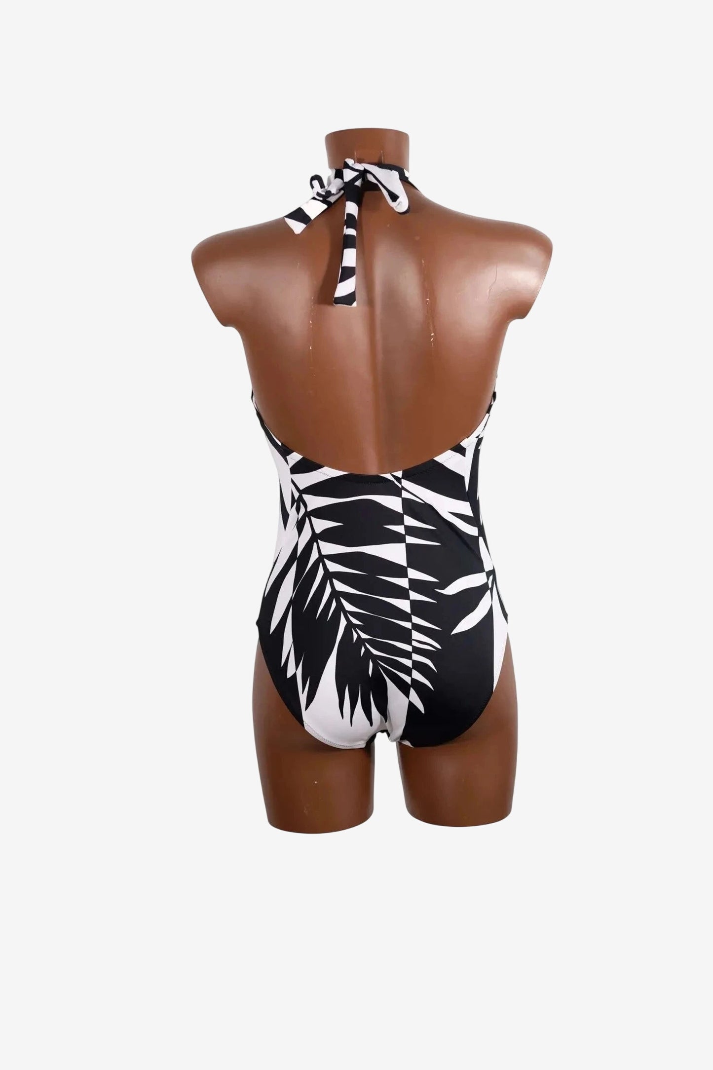 Costume intero Roidal con stampa a foglie bianche e nere e allacciatura al collo.