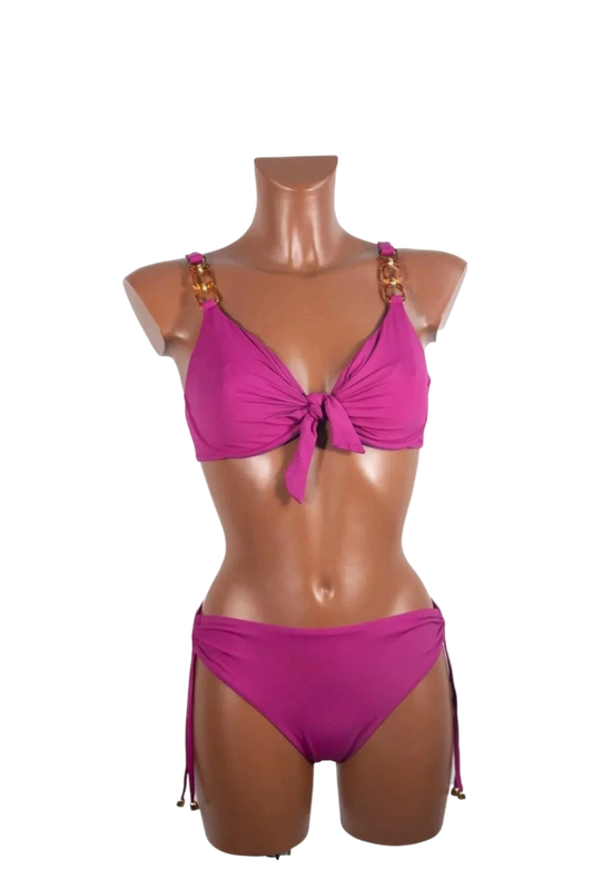 A magenta underwire bikini set featuring gold chain strap details and a front tie closure.