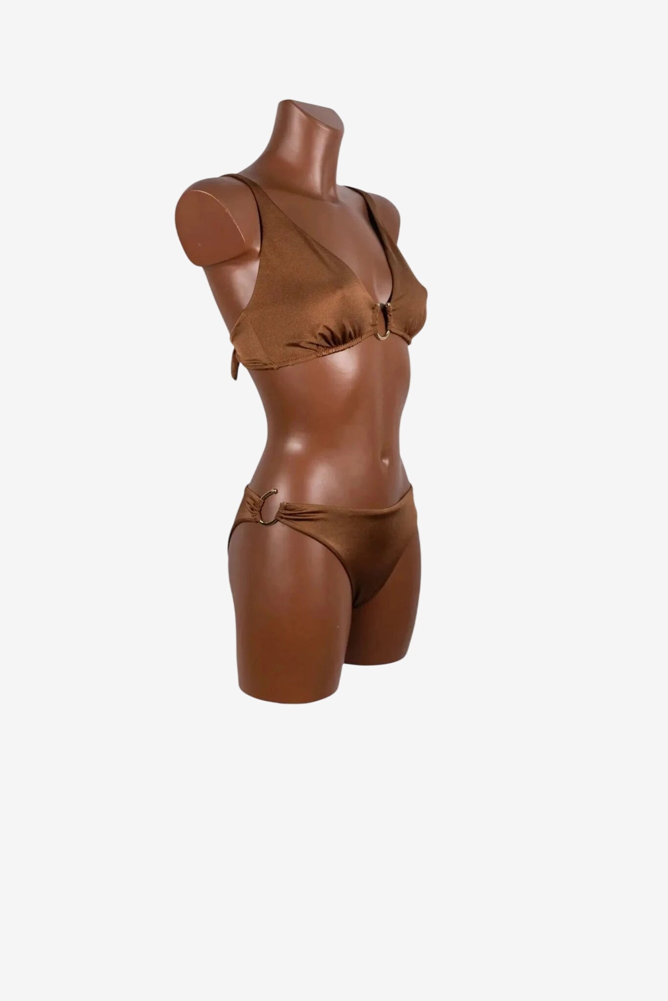 A brown bikini set with gold ring hardware on a mannequin torso.