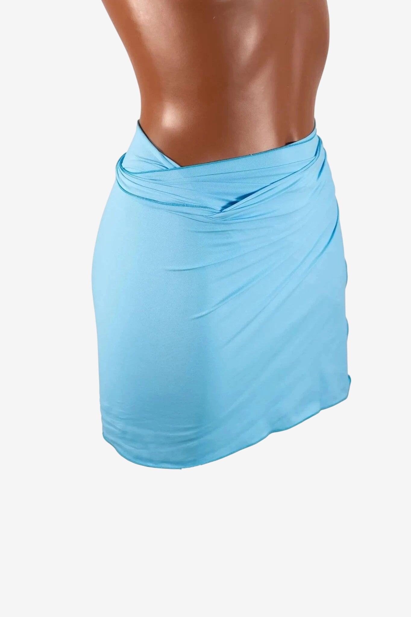 A light blue mini pareo in lycra worn around the waist.