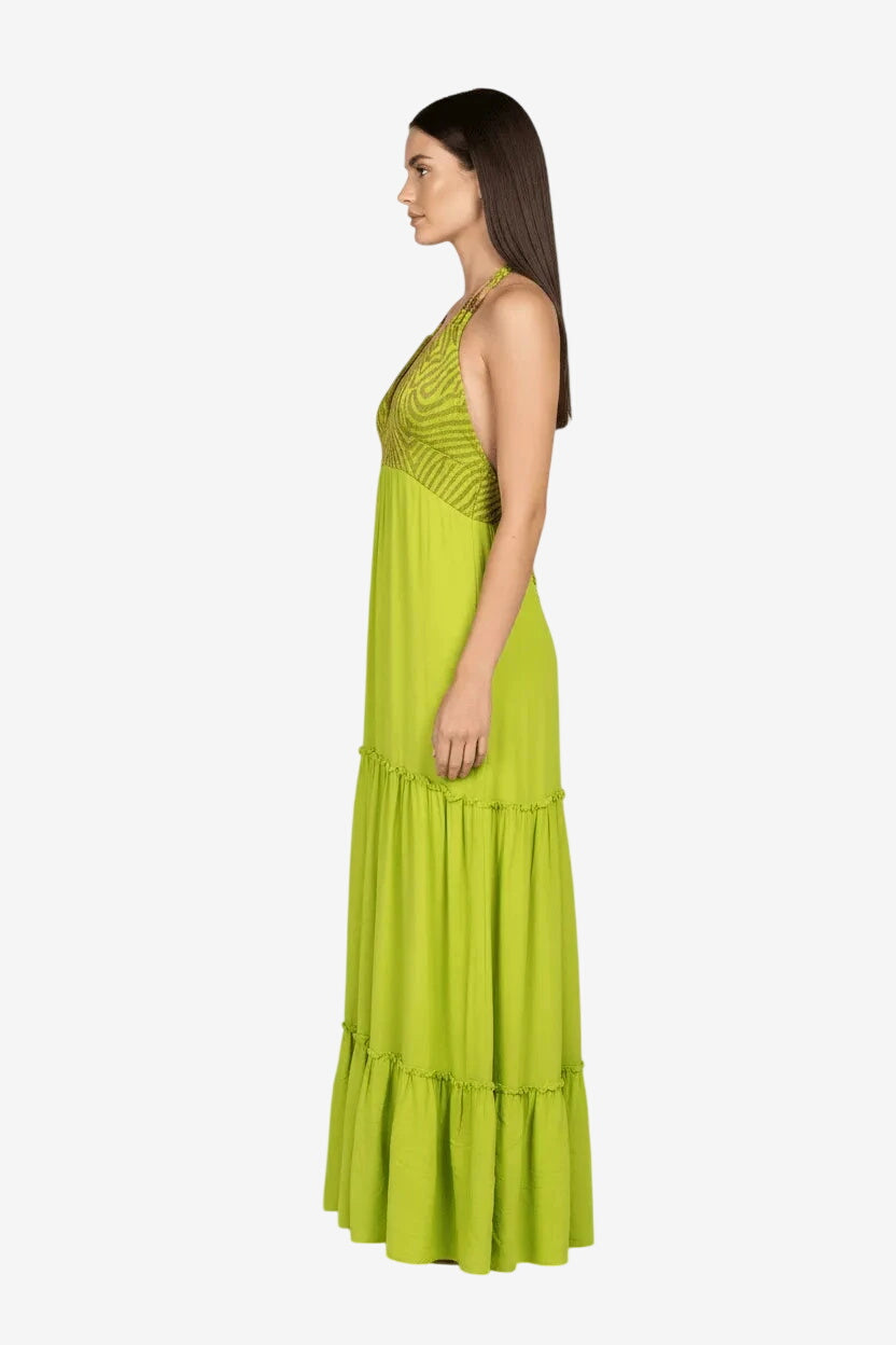 Abito lungo verde lime con busto a triangolo in lurex e gonna a balze.
